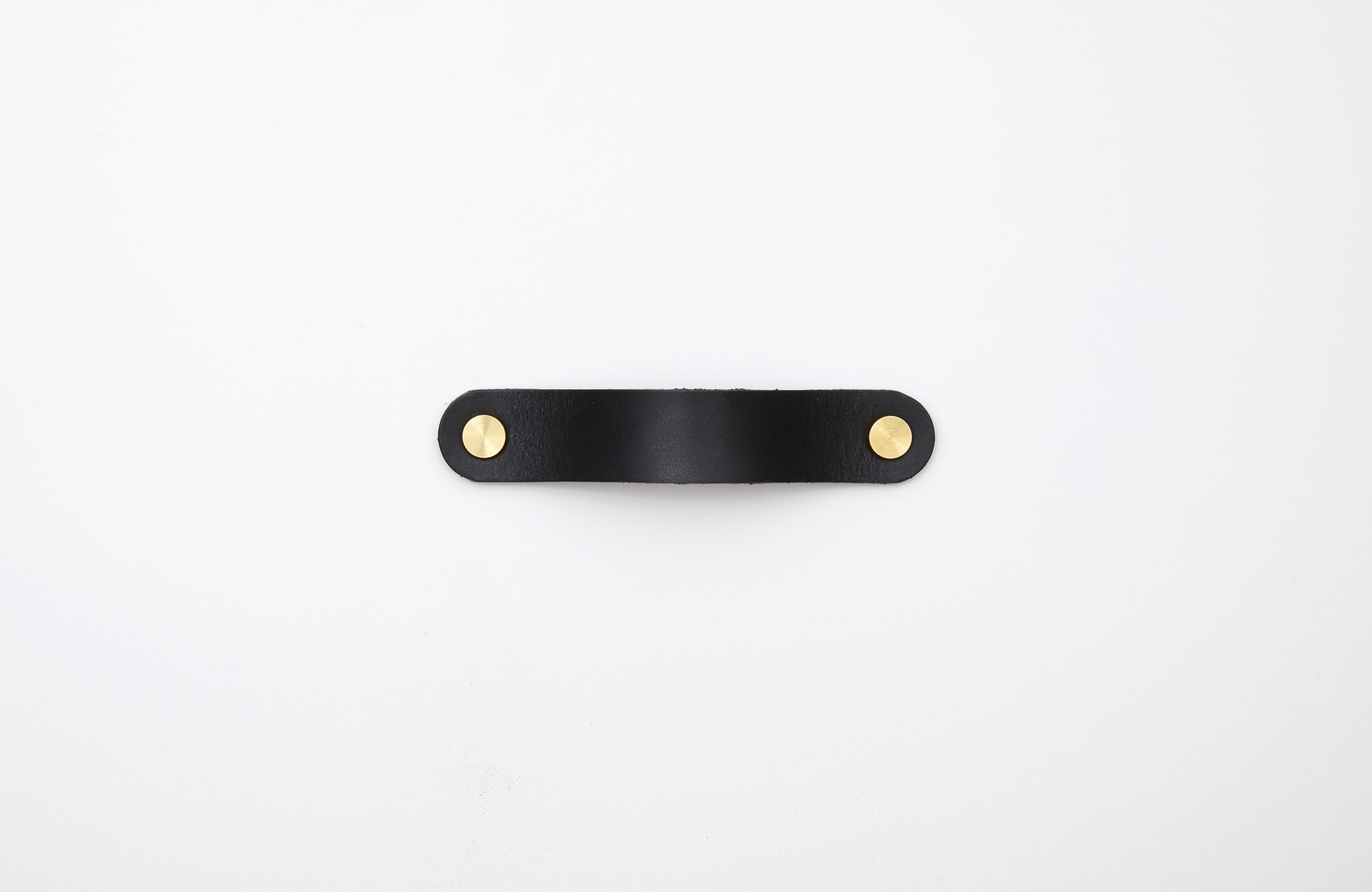 Black leather pull with solid brass studs