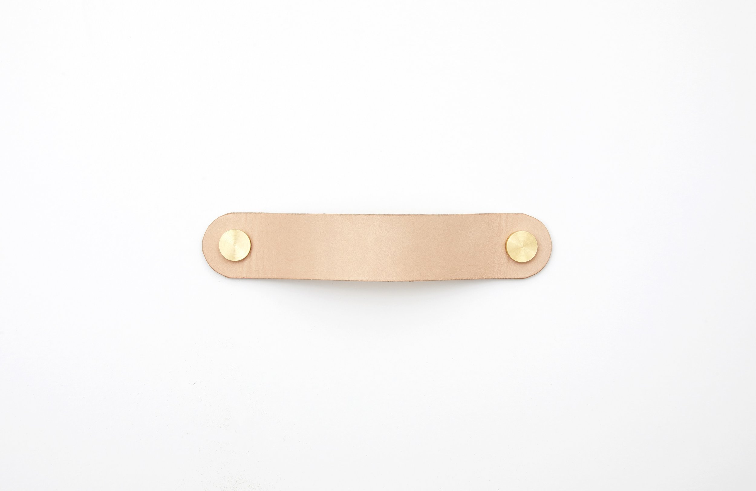 Natural skirting leather pull with solid brass studs