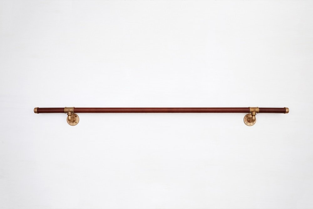 Brown leather handrail with industrial brass supports
