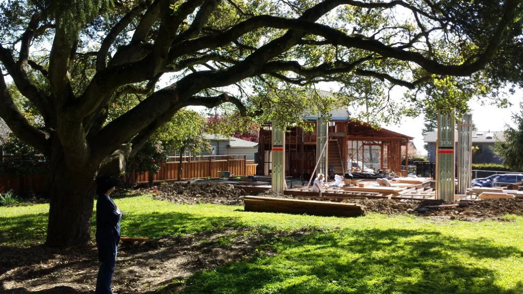 Rear of home with new high roofed great room taking shape 