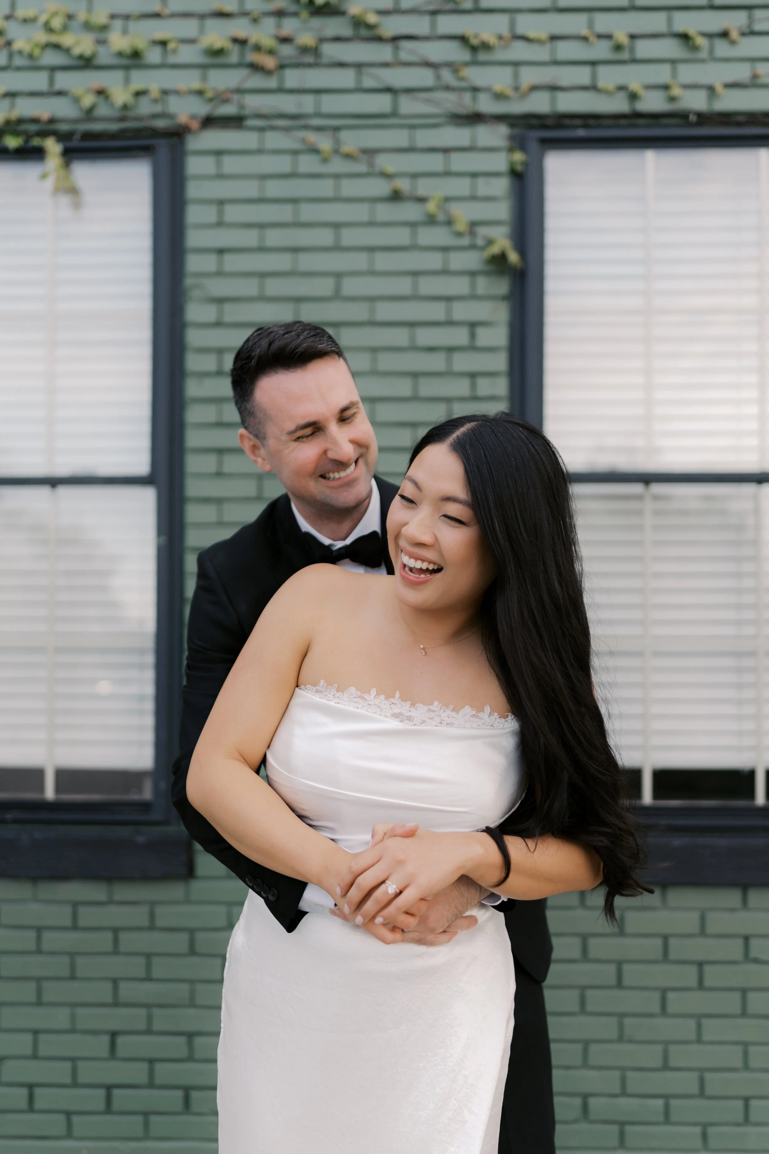 Candid wedding portraits at The Ivy House in Milwaukee with natural light and greenery