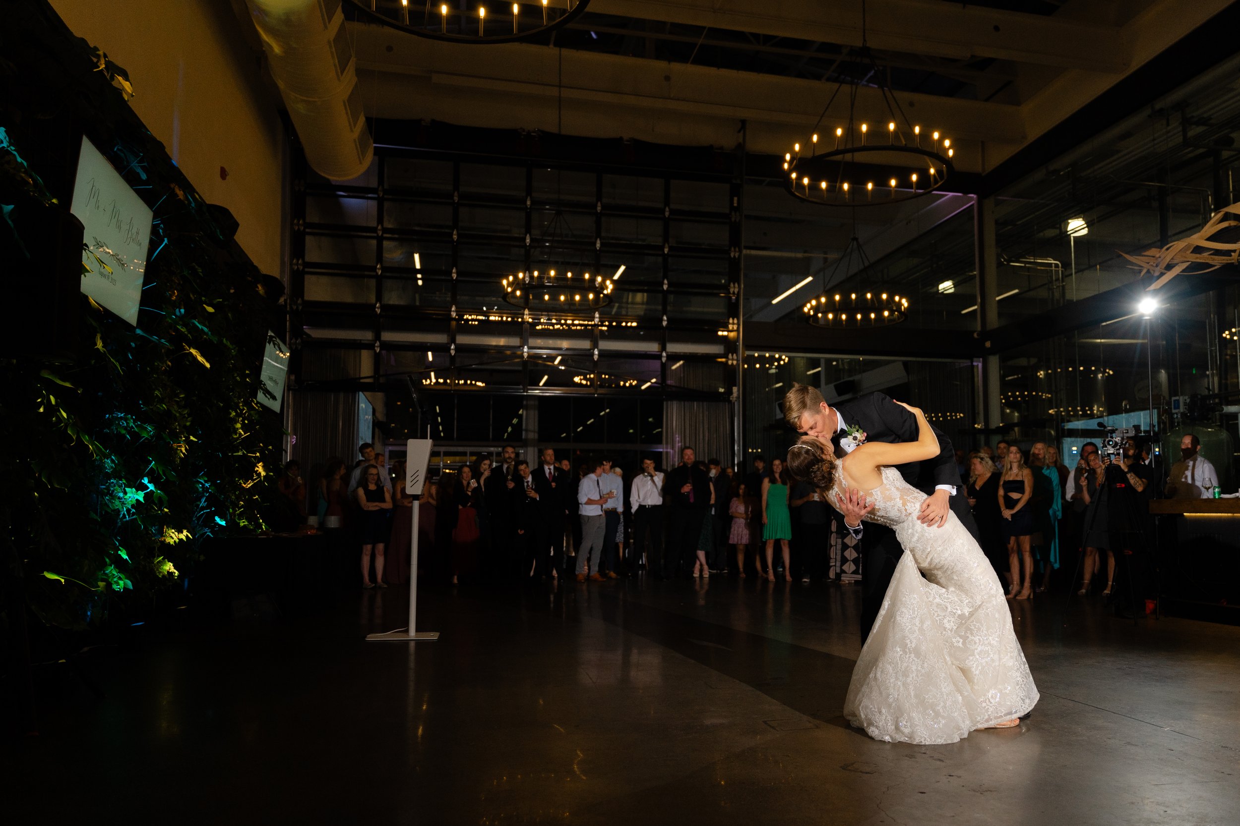 A groom dips his bride during their first dance at Pilot Project in Milwaukee