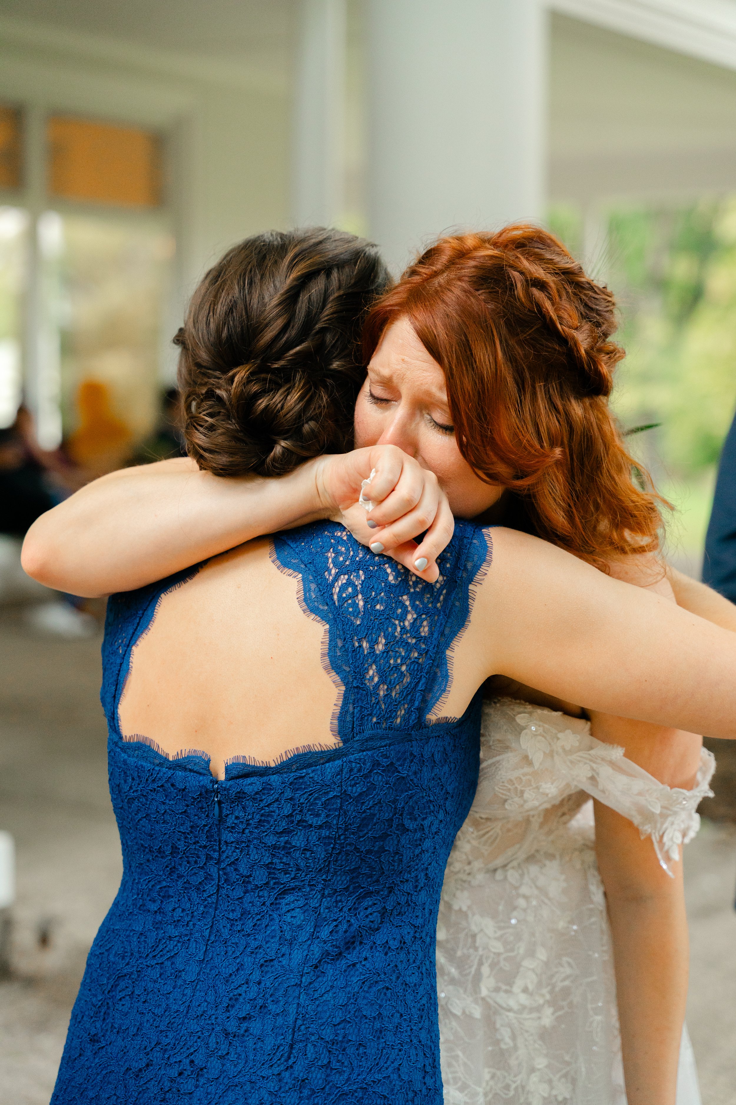bride shares a heartfelt moment with her bridesmaids on her wedding day in Oconomowoc