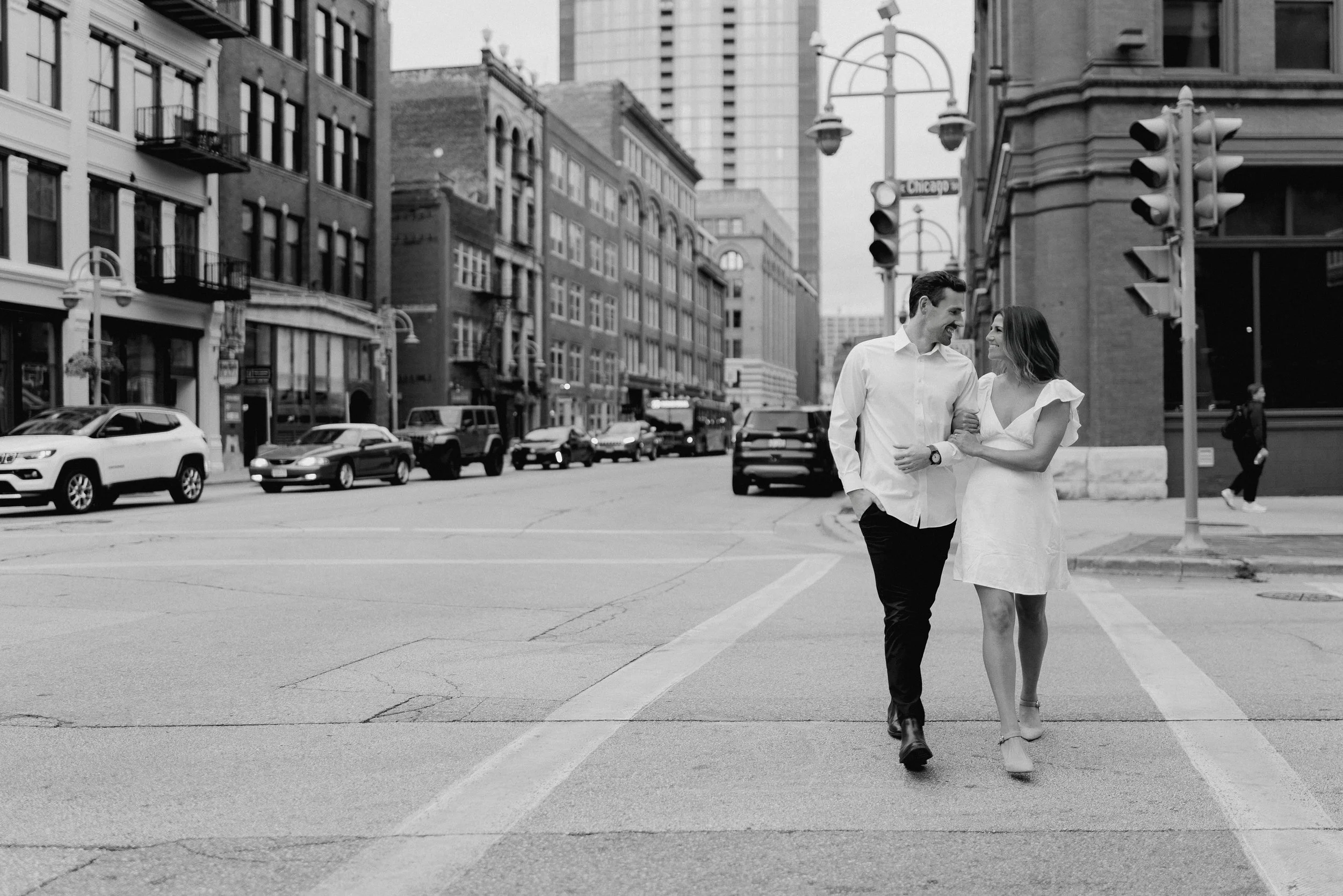Engagement photos in Milwaukee’s Third Ward with brick buildings and city charm
