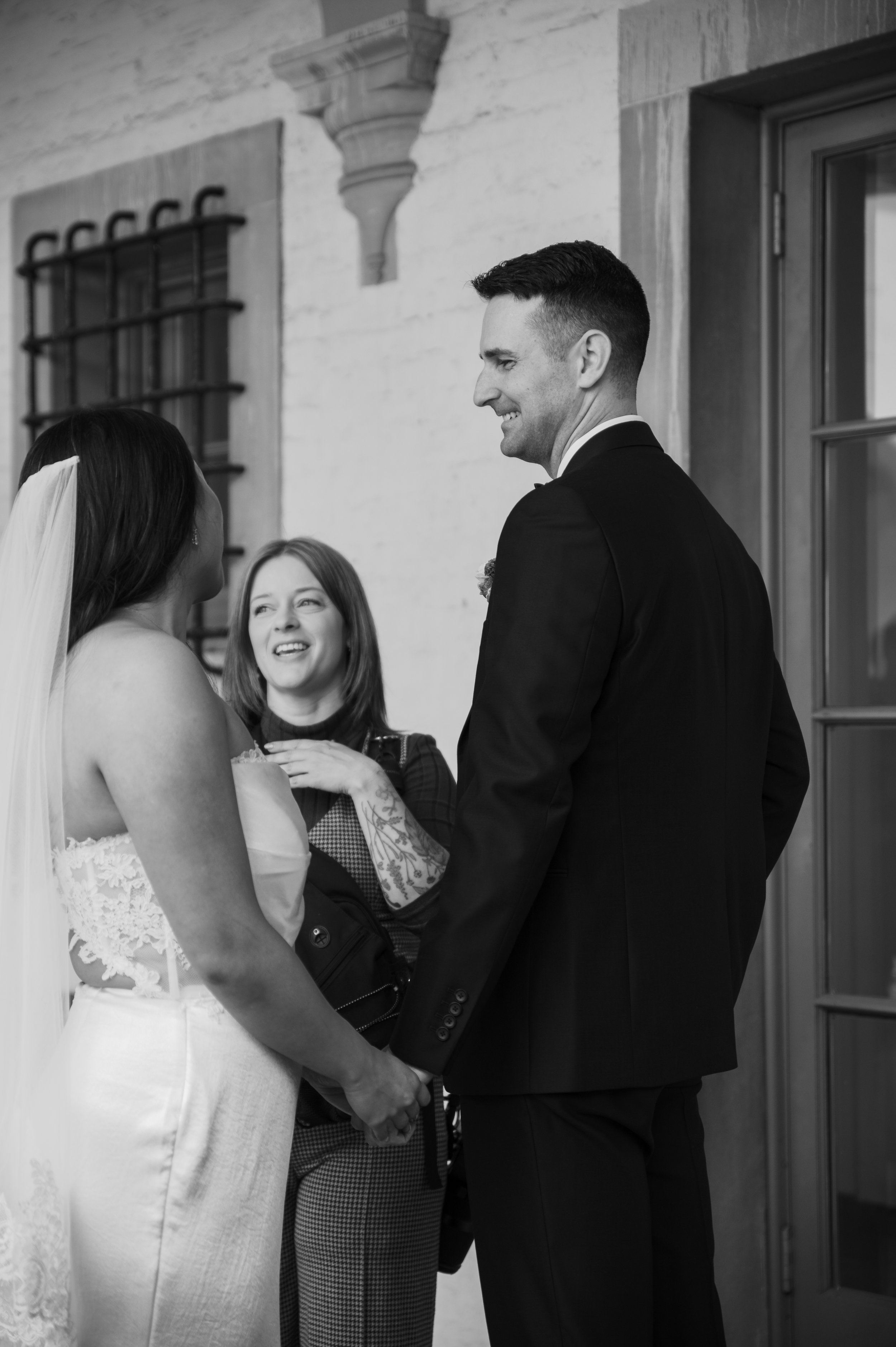 Milwaukee wedding photographer laughs with couple on wedding day.