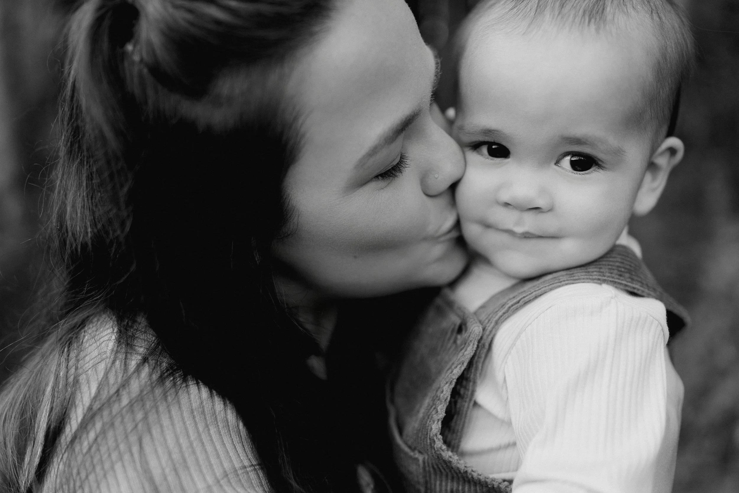 Toddler with parents during West Bend family photos