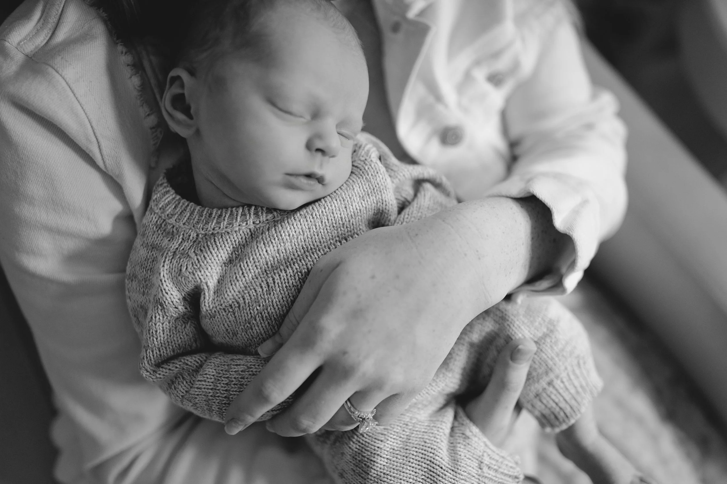 A mother holds her baby during his newborn photos in West Bend, Wisconsin.