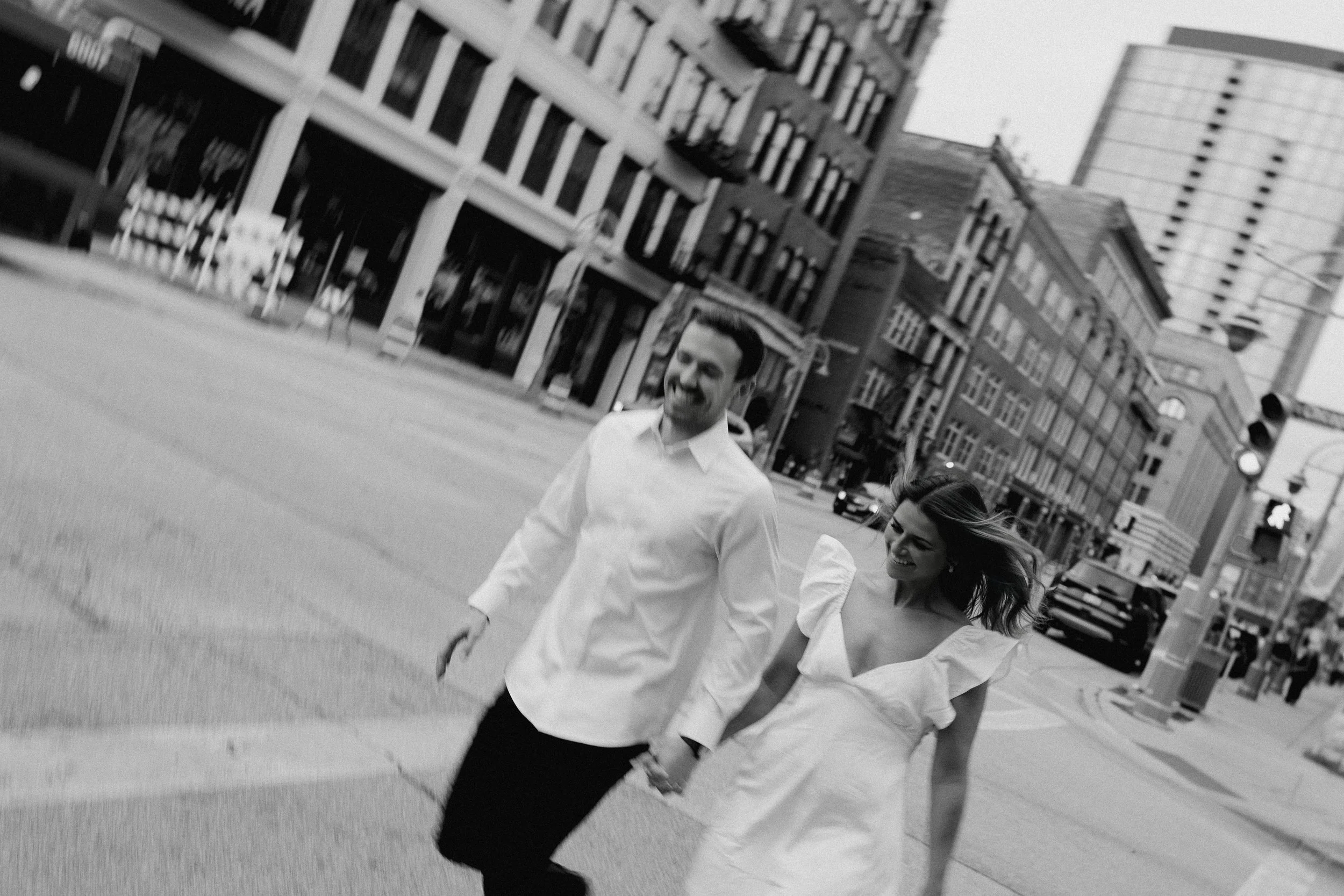 A candid photo of a couple during their engagement session in downtown Milwaukee