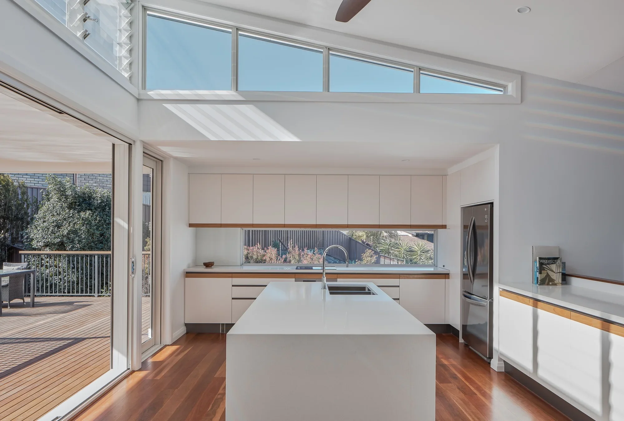 Minimal kitchen design in Cammeray home with skylight and custom joinery