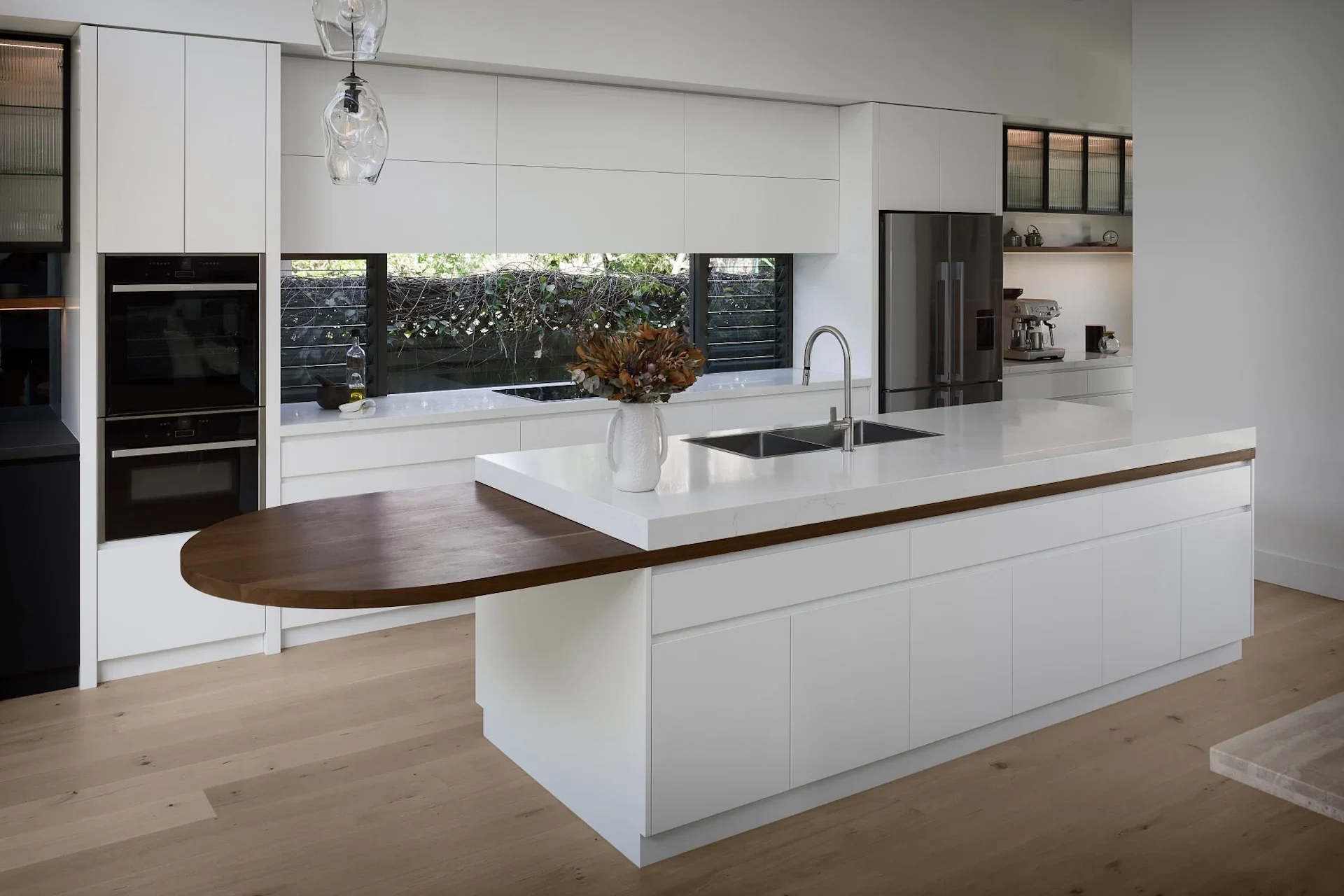 Modern kitchen with island bench, natural materials and clean architectural lines.