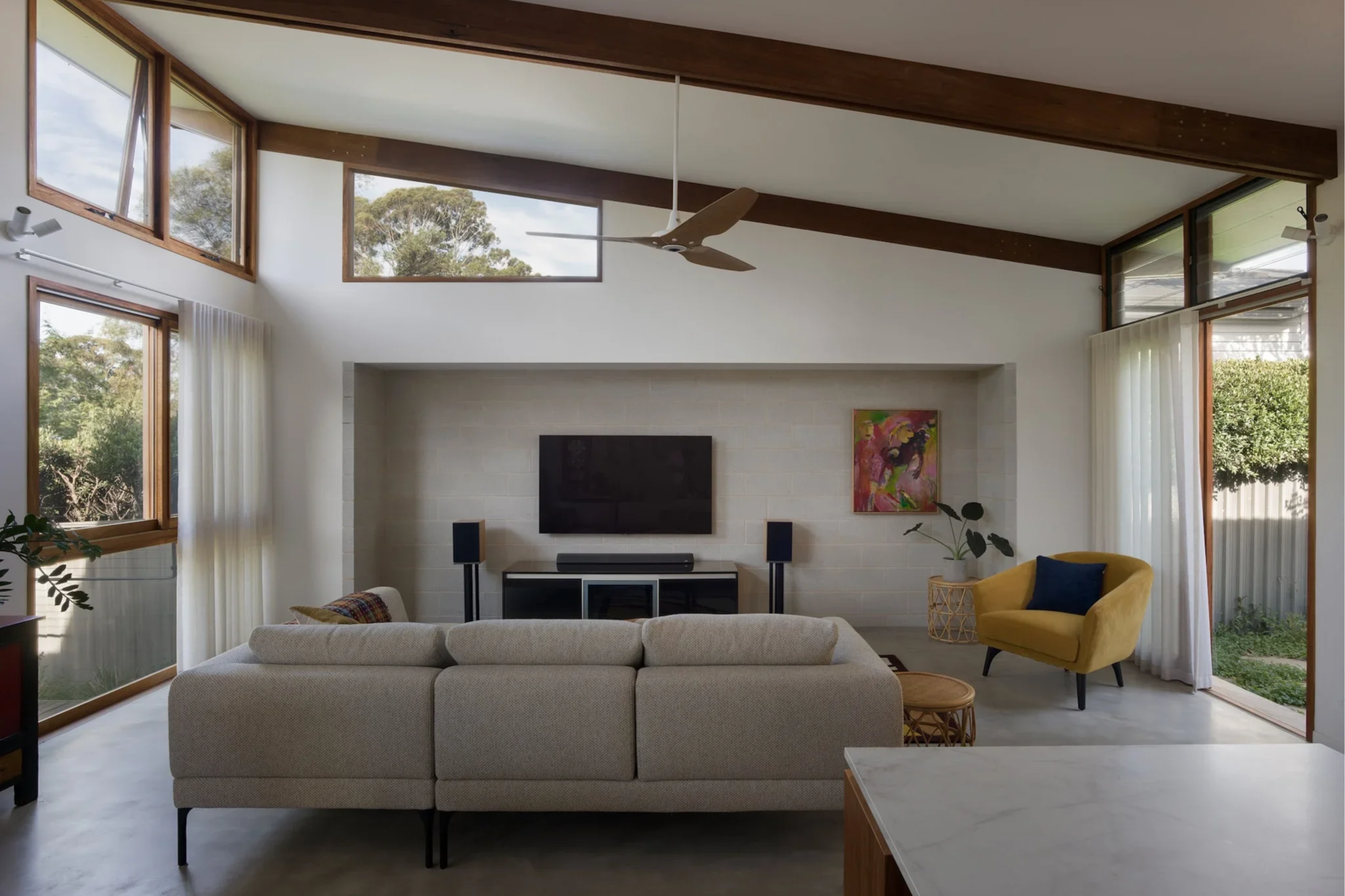 Light-filled living space in a Lindfield home, featuring high ceilings, timber beams and a strong connection to the garden.