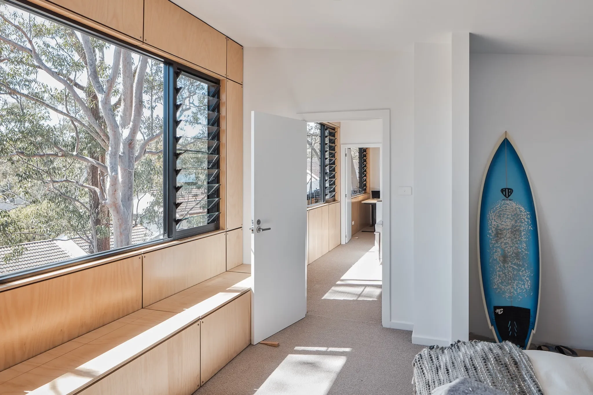 Window seat and surf board with natural light in Curl Curl home