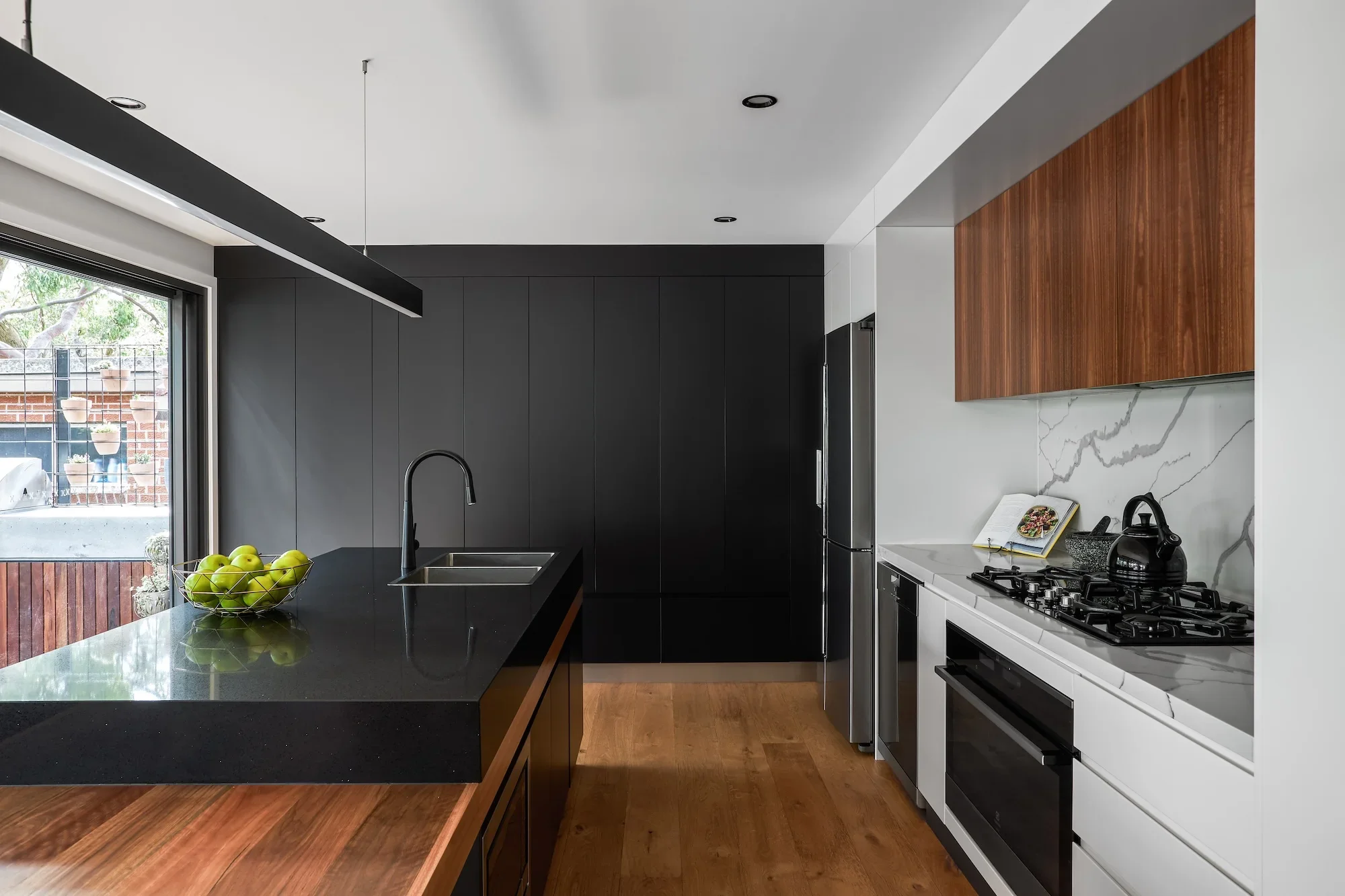 Renovated black kitchen by Ironbark Architecture in Sydney