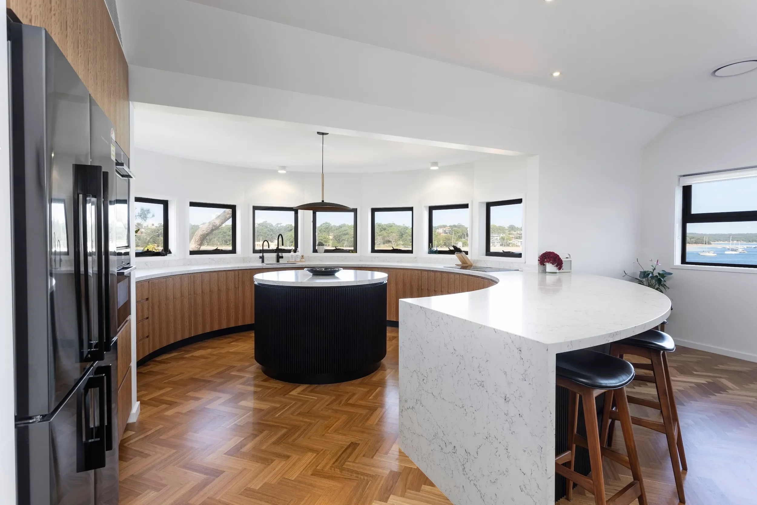 Curved kitchen integrated into heritage home