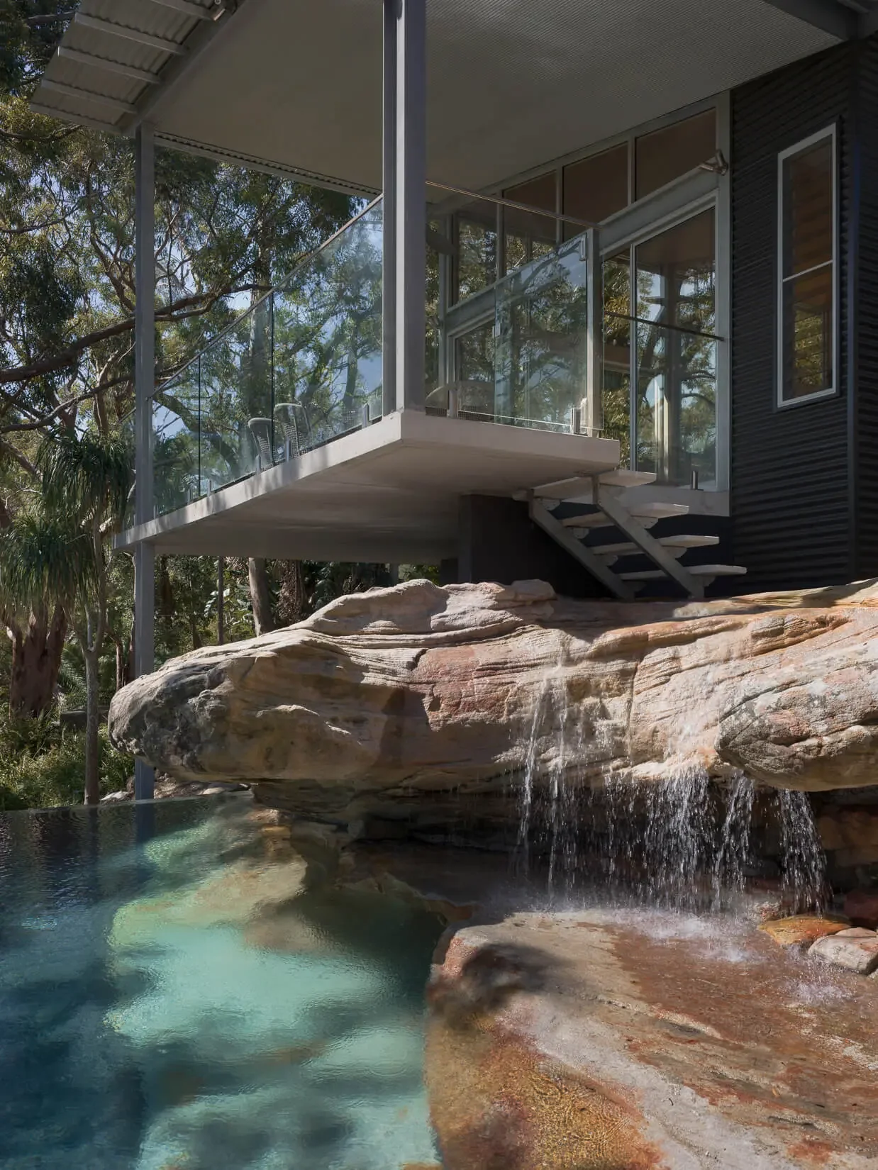Swimming pool integrated into sandstone landscape in Sydney area