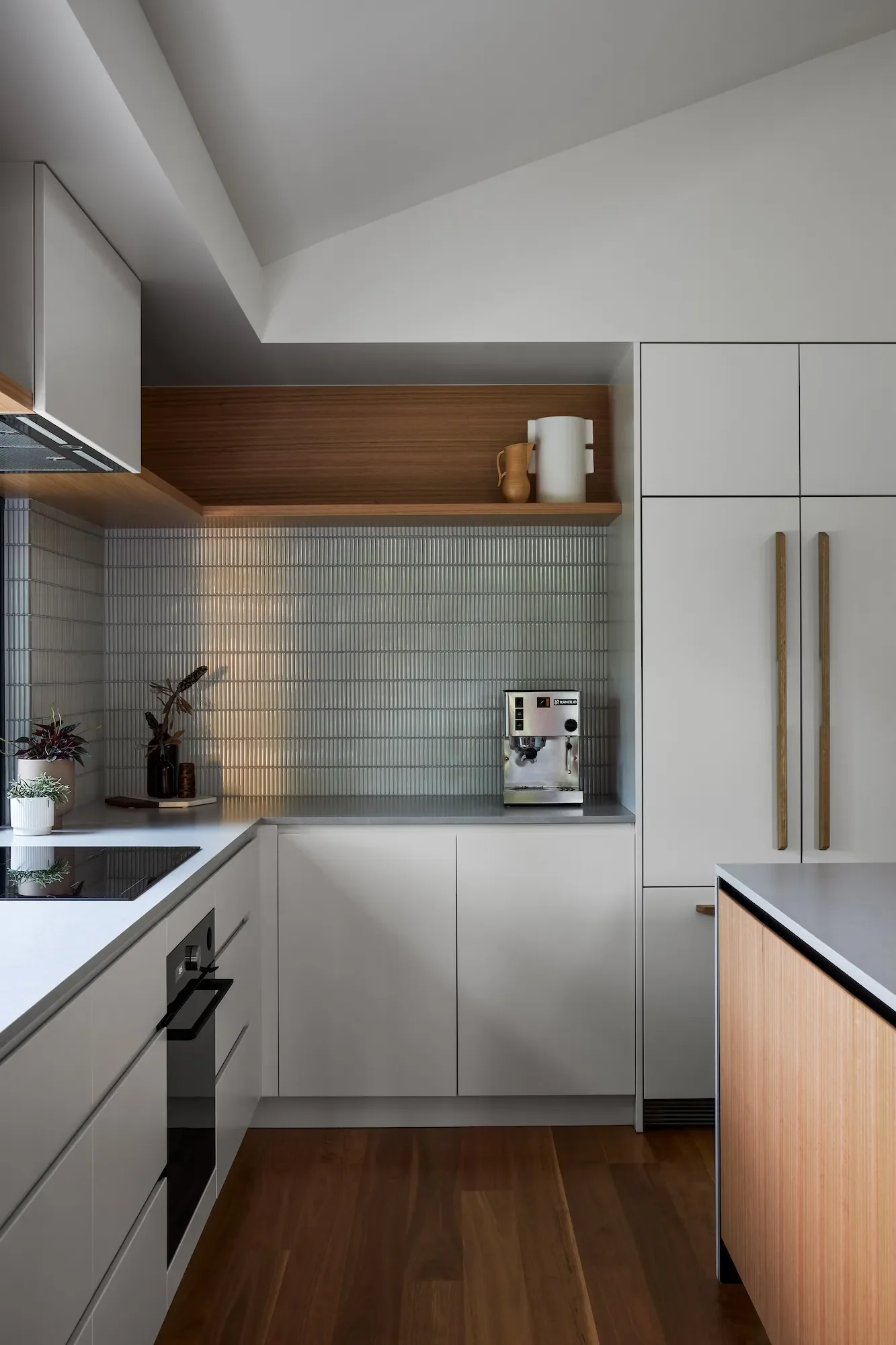 Modern kitchen renovation featuring custom cabinetry, timber accents and integrated appliances.
