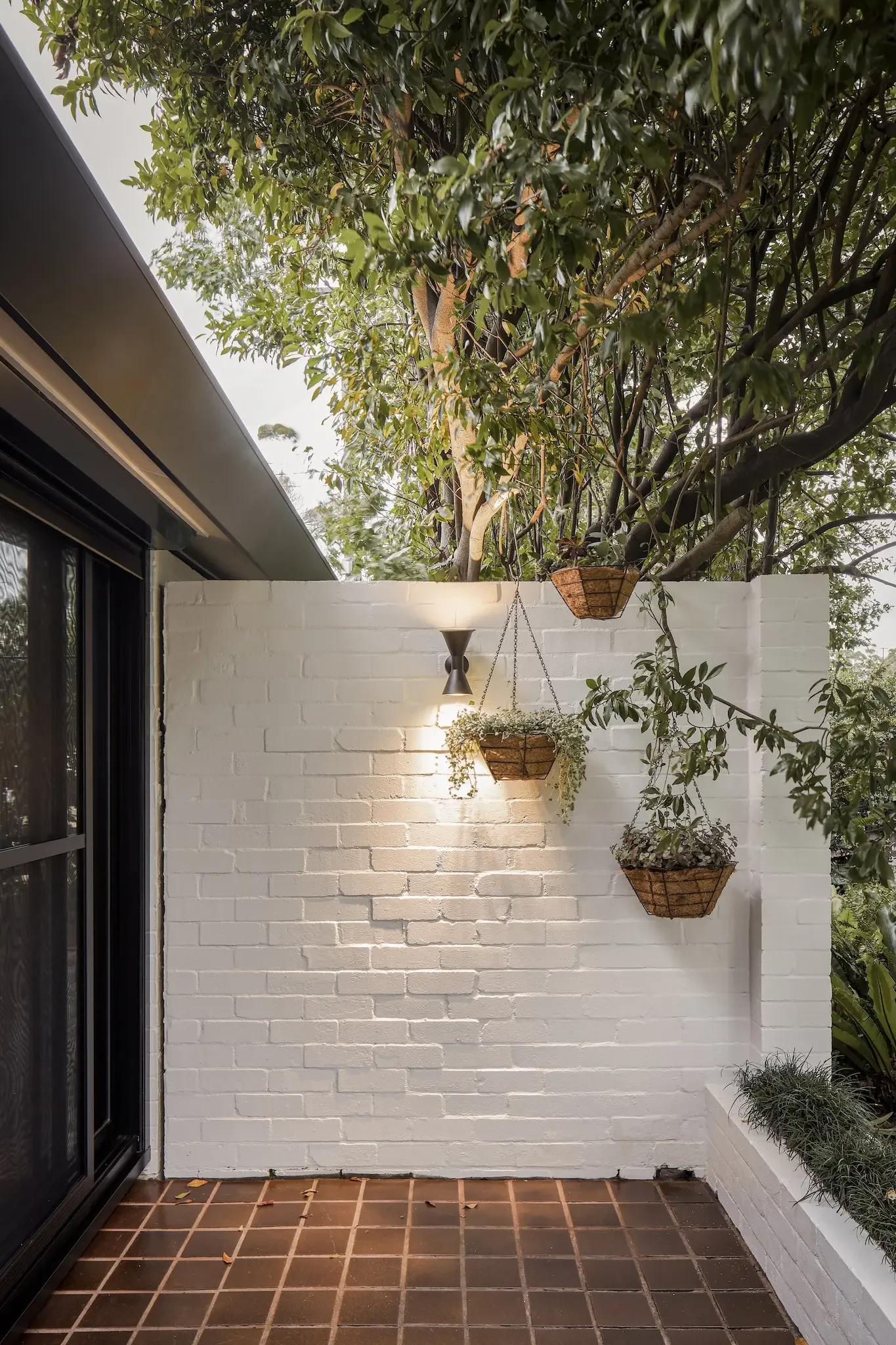 Renovated Pettit Sevitt courtyard with light and shadow in bushland home