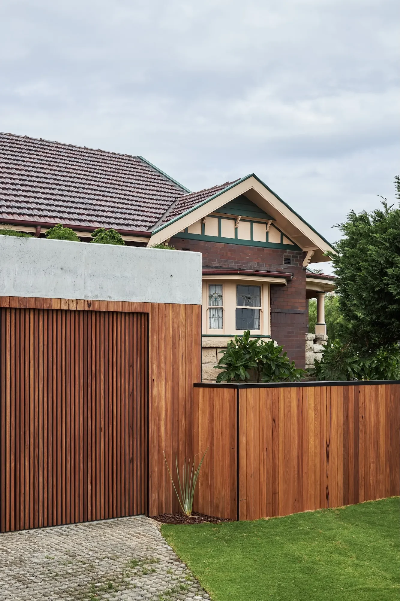 Renovated heritage home facade with timber fence in Sydney