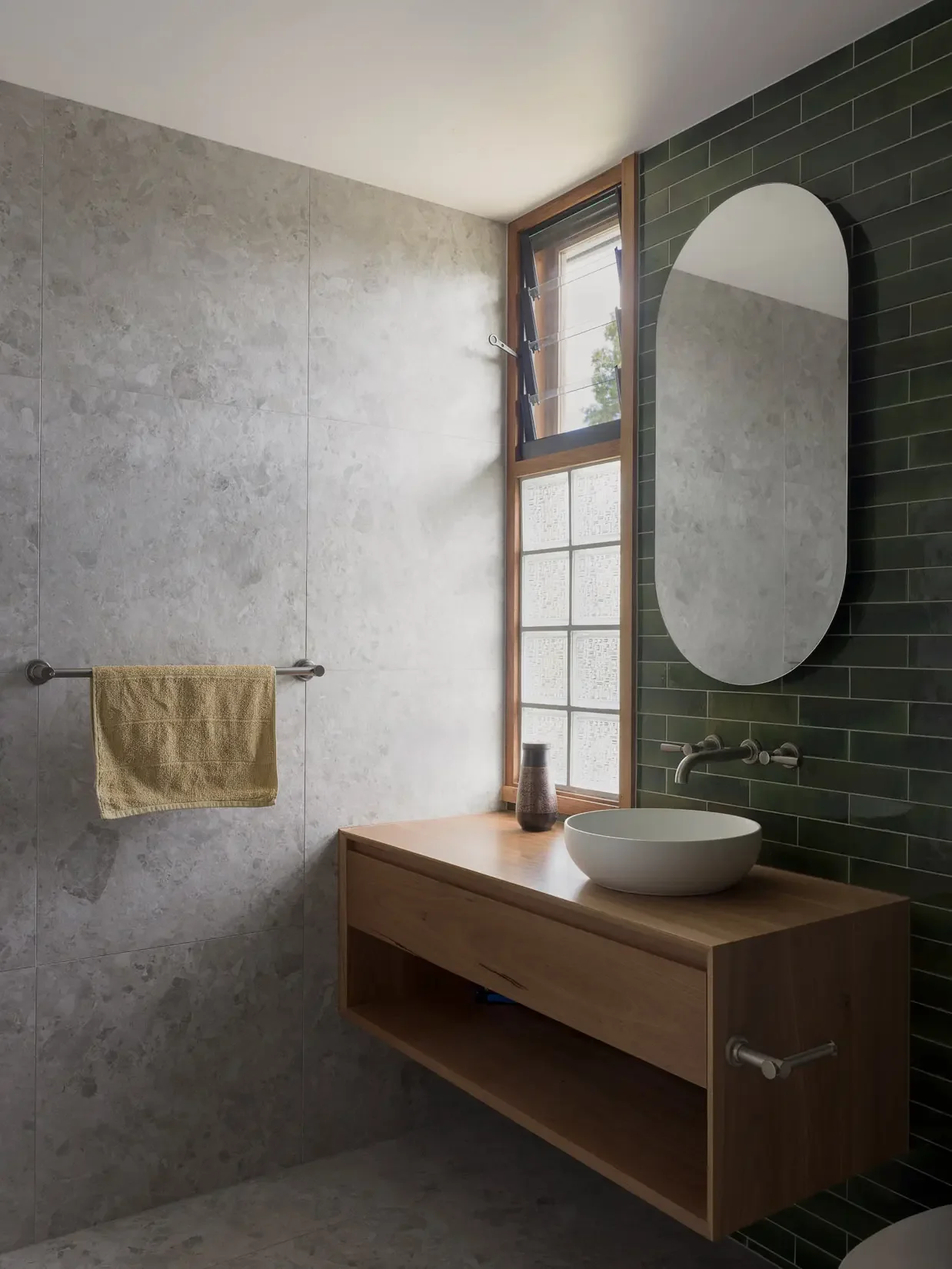 Bathroom with green tiles at Beela House in Sydney by Ironbark Architecture