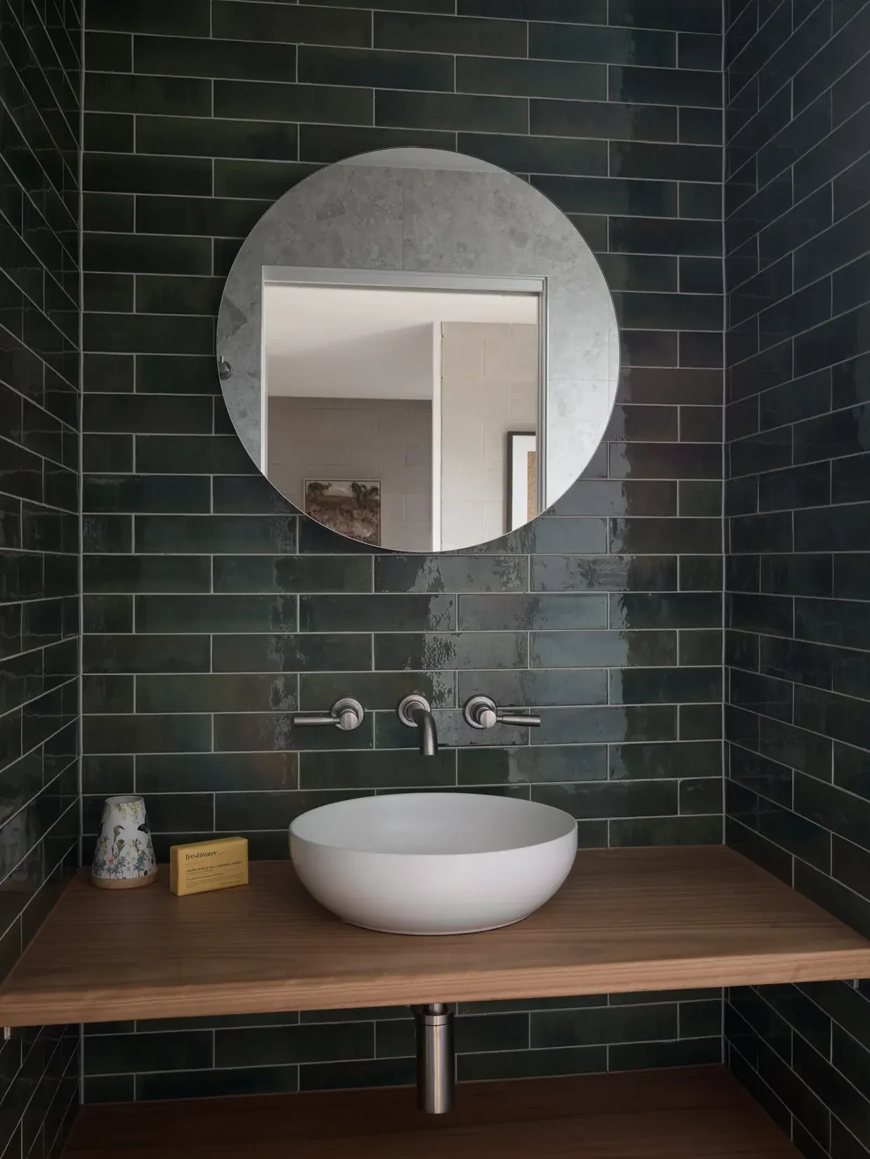 Bathroom with green tiles at Beela House by Ironbark Architecture