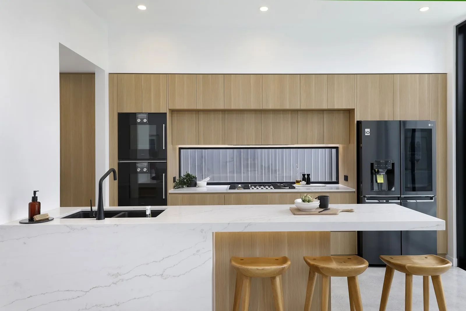 Minimalist kitchen in dual occupancy home