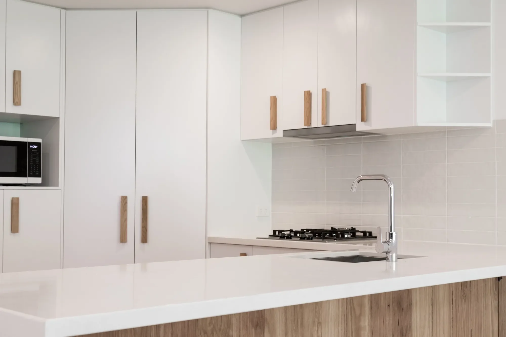 Kitchen interior with integrated storage in dual occupancy design