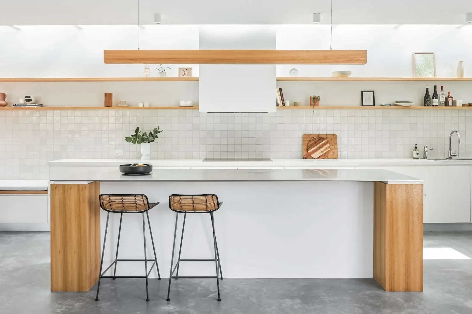 Minimal kitchen design in Castle Cove home with timber joinery and natural finishes