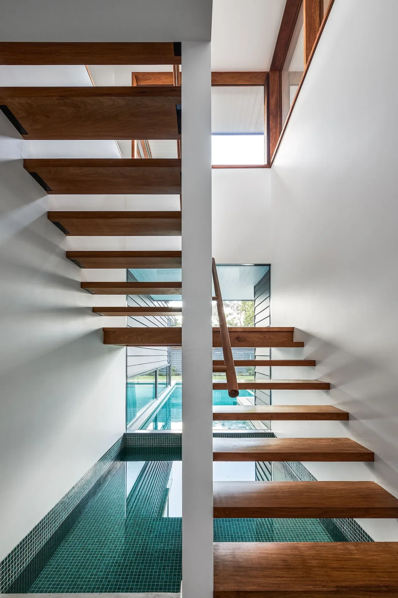 Open timber staircase with skylight bringing natural light through a Northbridge home