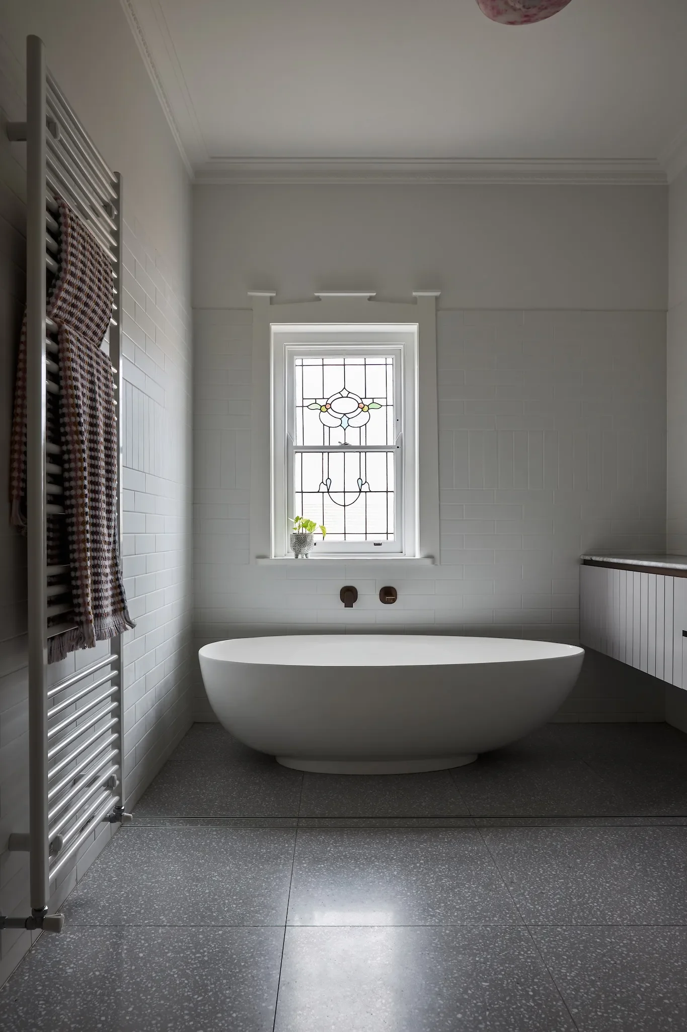 Renovated heritage bathroom keeping the leadlight windows