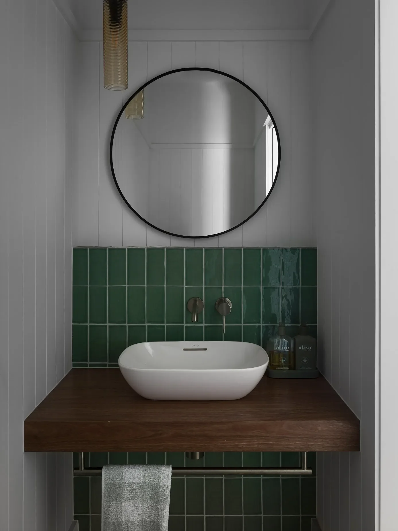 Bathroom vanity with round mirror detail