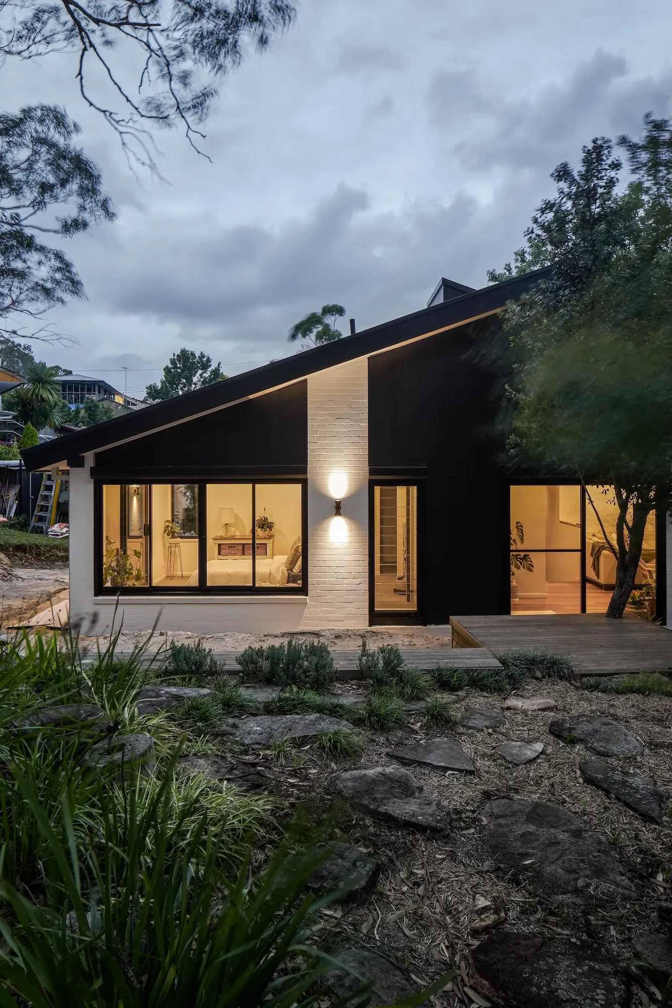 Renovated Pettit and Sevitt bushfire resilient home at dusk in natural setting