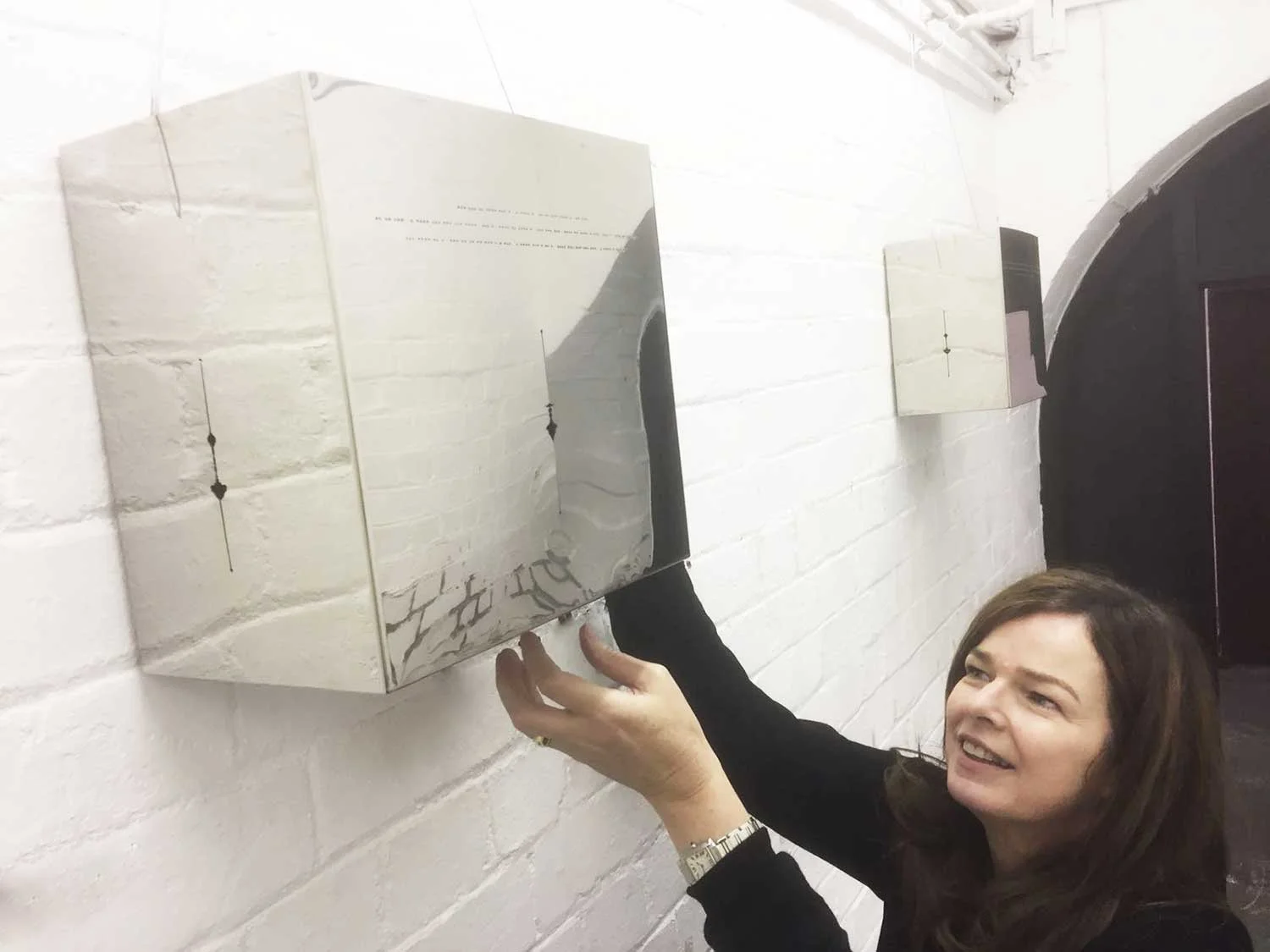 Caro Williams installing Call and Response in the Cells, Trowbridge Town Hall (Photo: Bob Mytton)