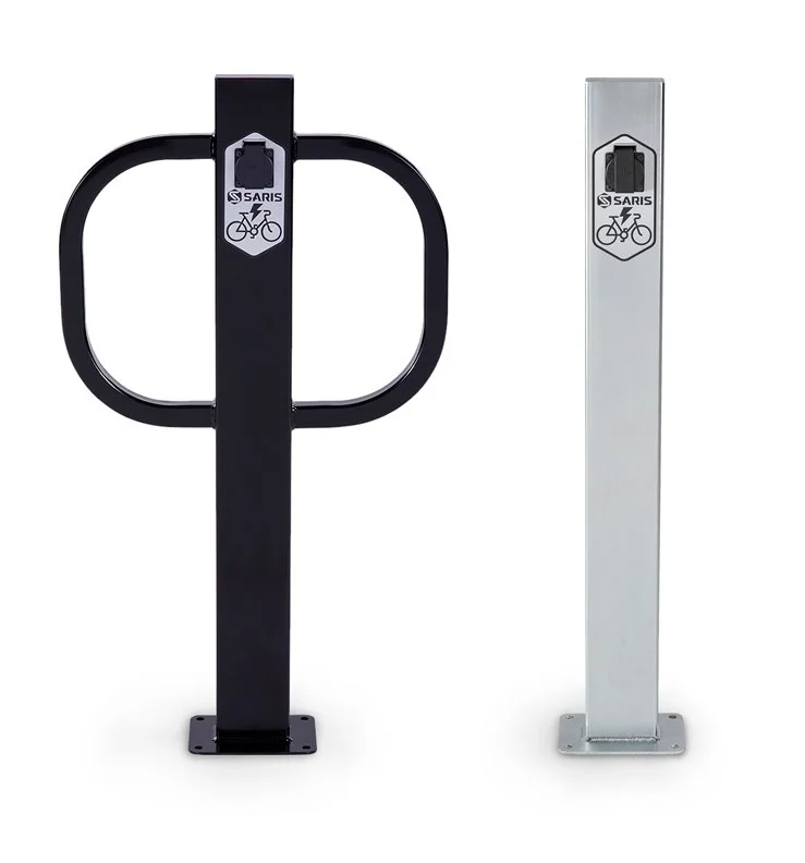 A bike rack and a charging station post each with two charging ports.