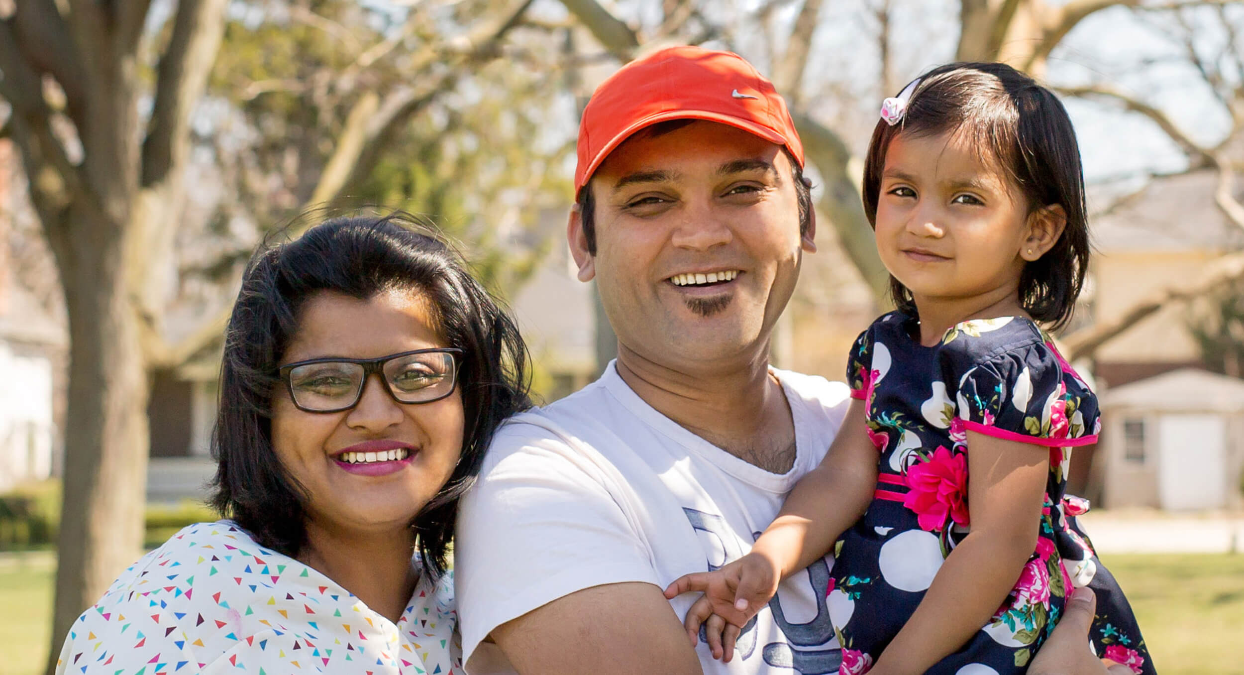 Saloni, Jimmy, and Reet on "The Green" in their Wortley neighbourhood, enjoying a picnic with new friends.