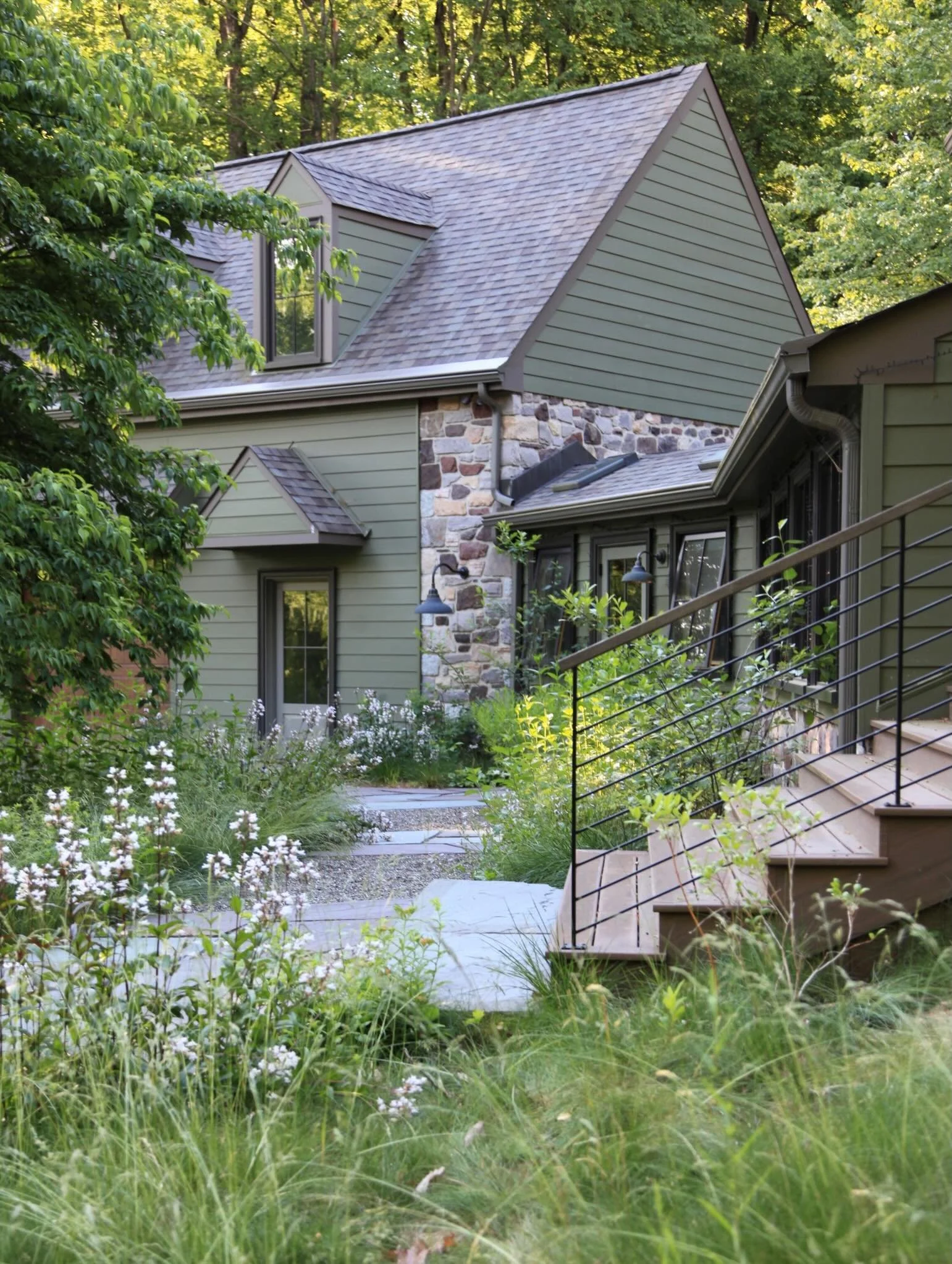 Happy 2nd Birthday to this gorgeous design-build!

Before, the front entry dogwood orphaned in a swathe of asphalt spoke volumes. This thoughtful home renovation was desperately missing connection with the landscape. When a home is integrated into it
