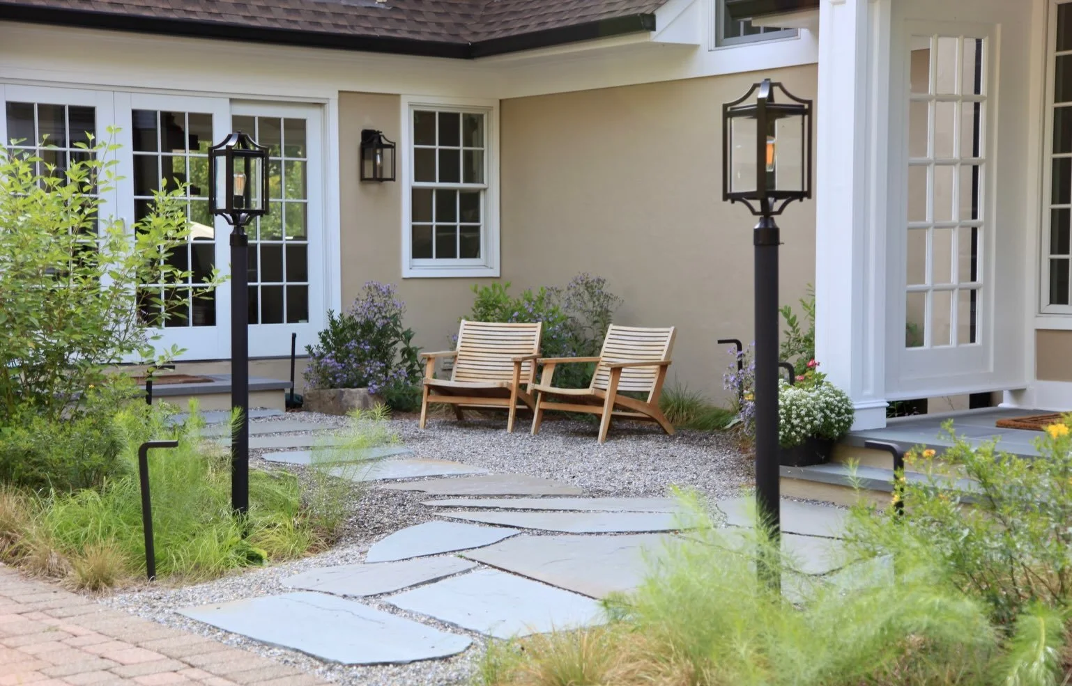 Entryways to a home set a vibe. 

At our Princeton design-build, the homeowner&rsquo;s focus was on the rear of the property. In later phases, we&rsquo;ve worked together to update the traditional landscaping in other areas to create design cohesion 