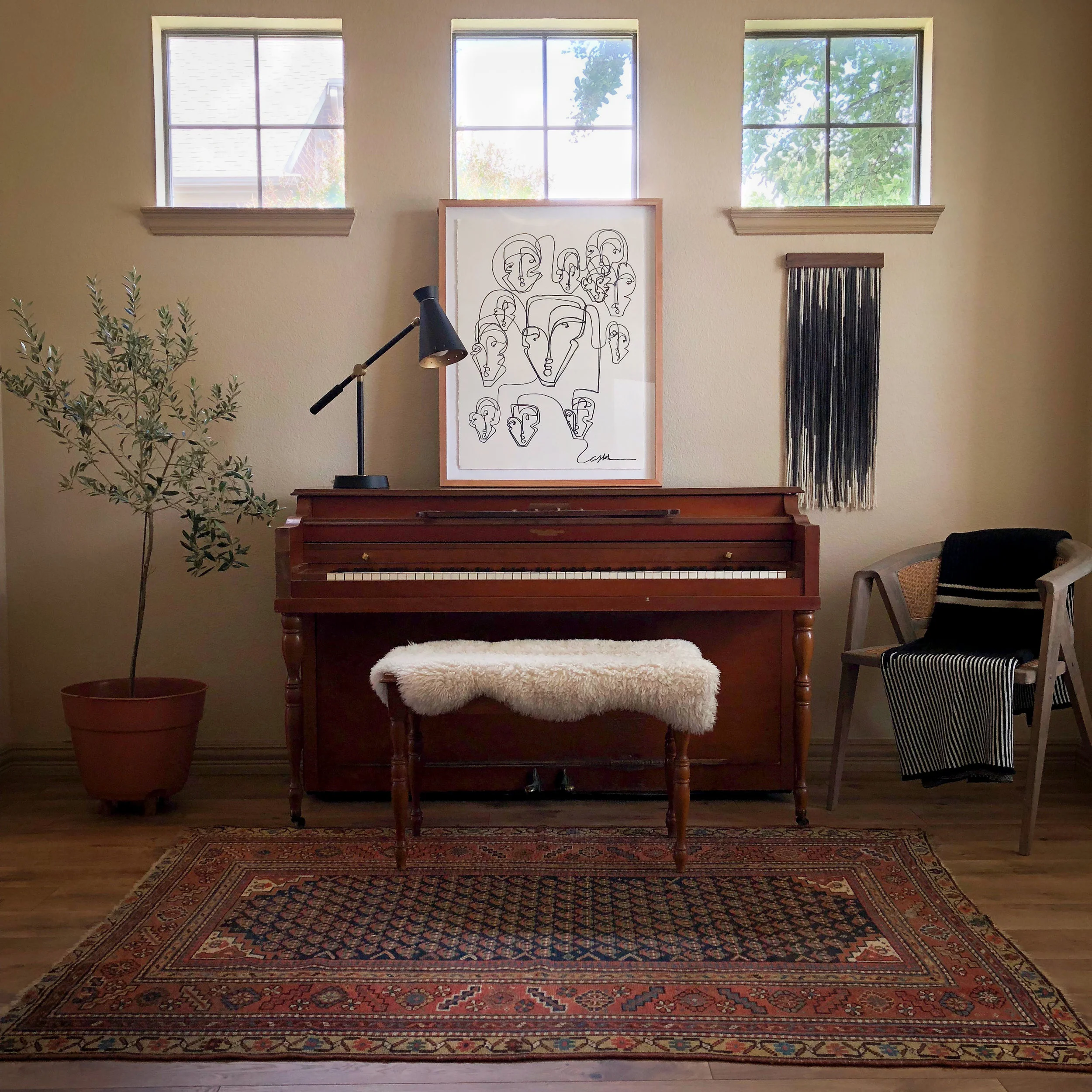 Mini Tapestry paired with framed art by Carly Kuhn of @thecartorialist in Lauren’s family piano room. Vintage upright piano and bench found on Craigslist. Vintage rug from Jean Palmer Home. Chair with Lauren Williams + Ditto House tapestry-inspired cotton knit throw available online: https://www.laurenwilliamsart.com/store
