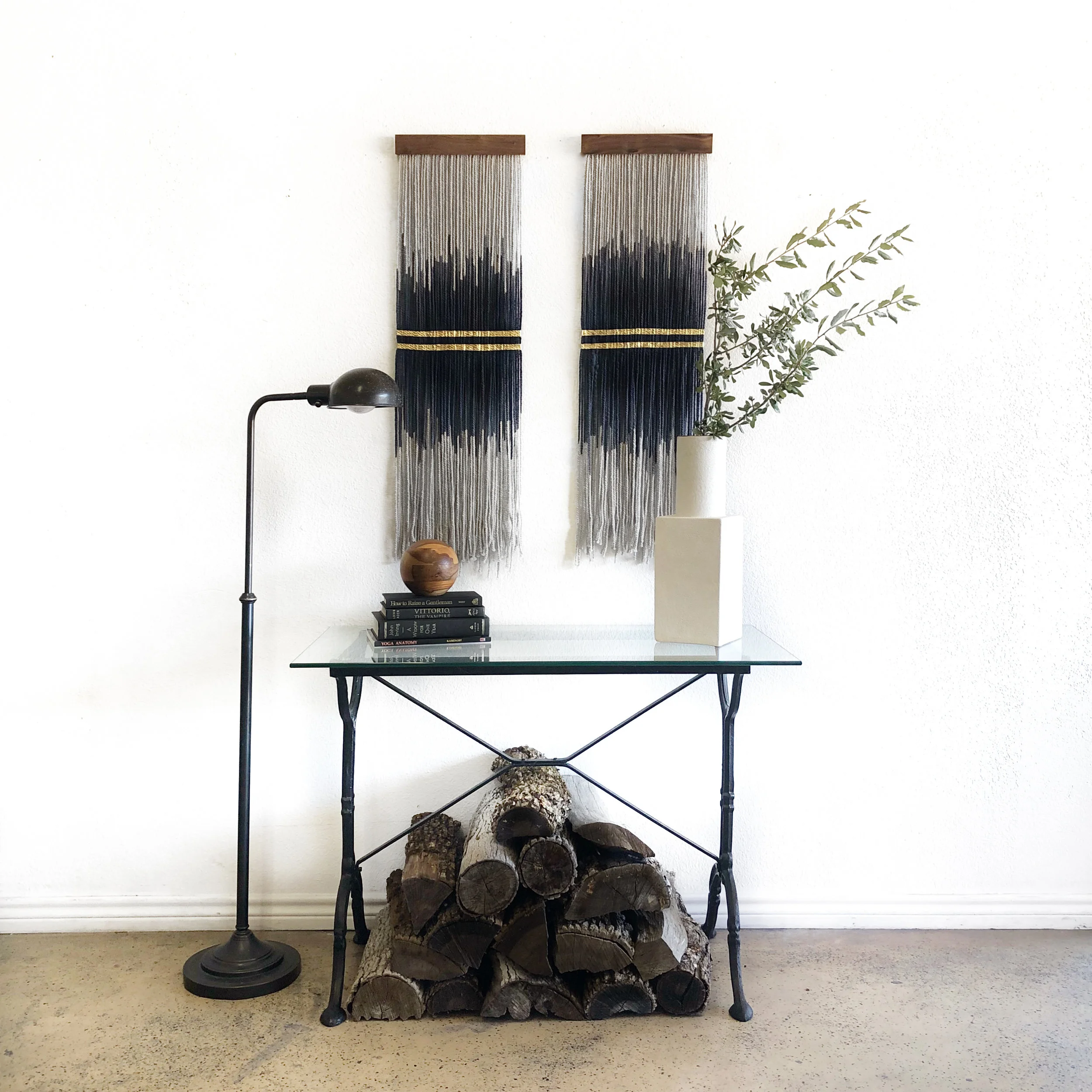 Mini Tapestries paired above vintage metal framed table with glass top. Standing lamp vintage from Lauren Williams’s personal collection. Vase by West Elm. Fiber art available online: https://www.laurenwilliamsart.com/store