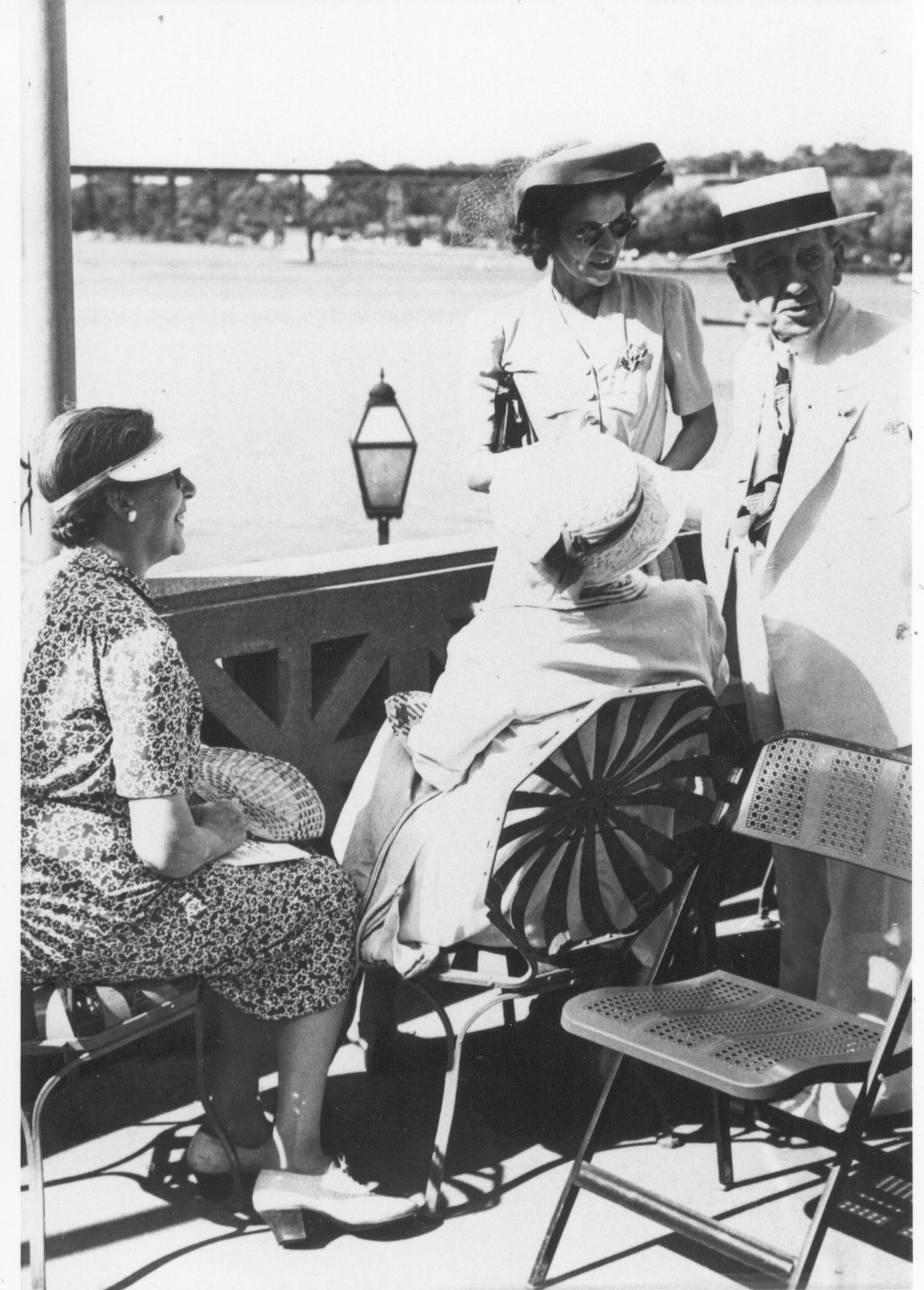 Mr. Baker and Dellora Norris, standing, at Hotel Baker.