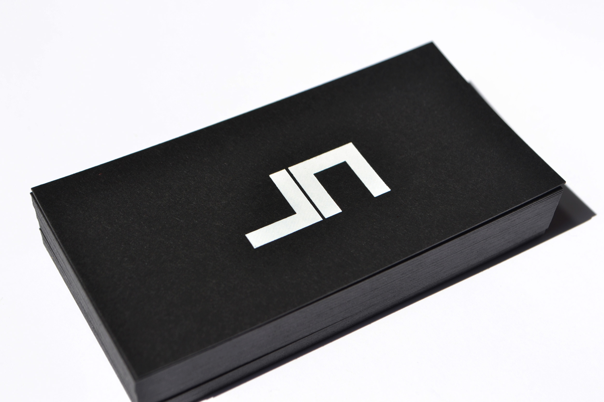  Joe Nasr is a developer who owns a construction company. He needed a logo that would represent him. Due to the nature of his work, his initials were designed in a squarish geometric shape. It was printed on 430gr black sirio paper.&nbsp;The logo was