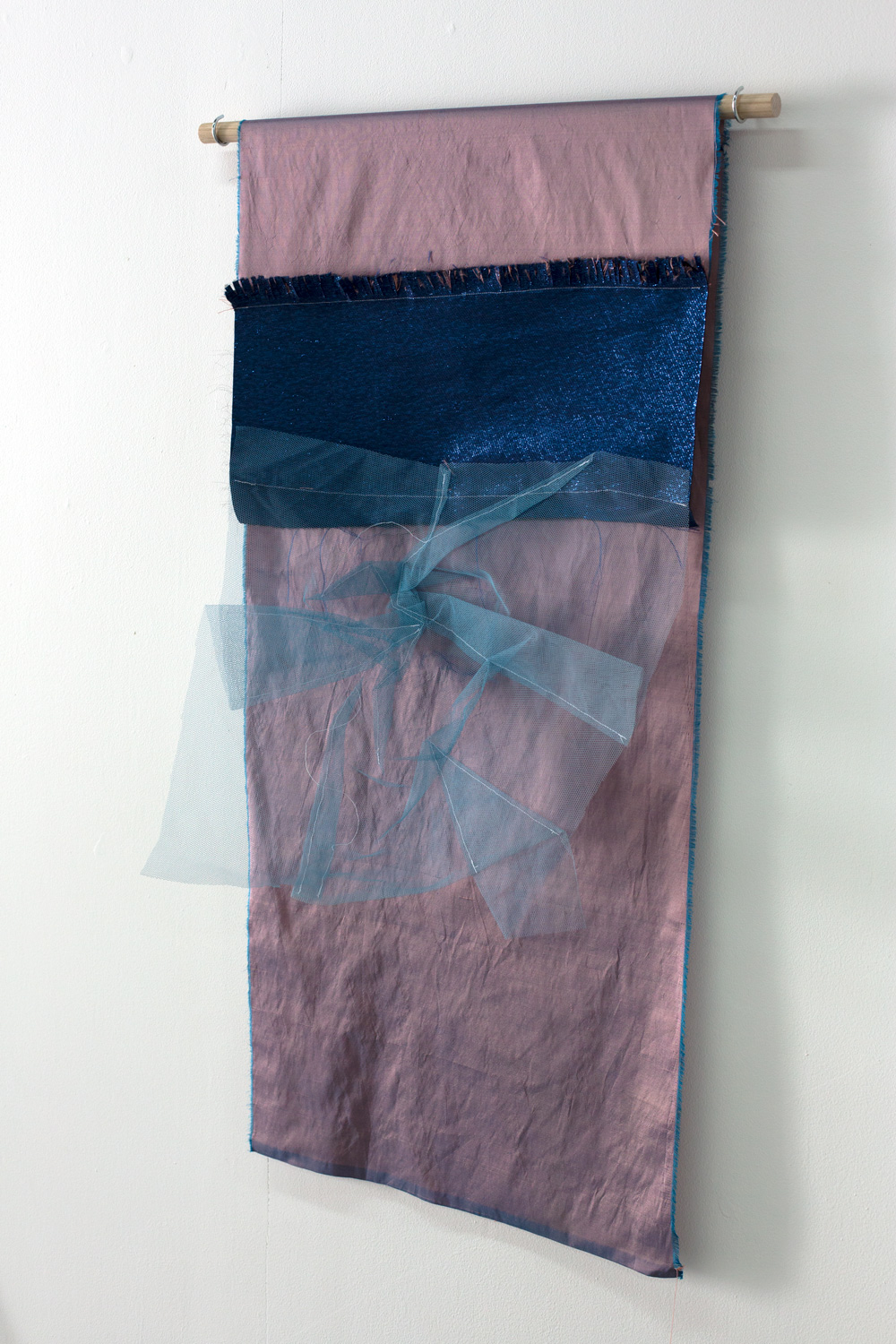   In the bed sheets , 2019, silk, polyester, tulle, thread, Tasmanian oak dowel, cup hooks, 100 x 58cm  Photo: Xavier Burrow 