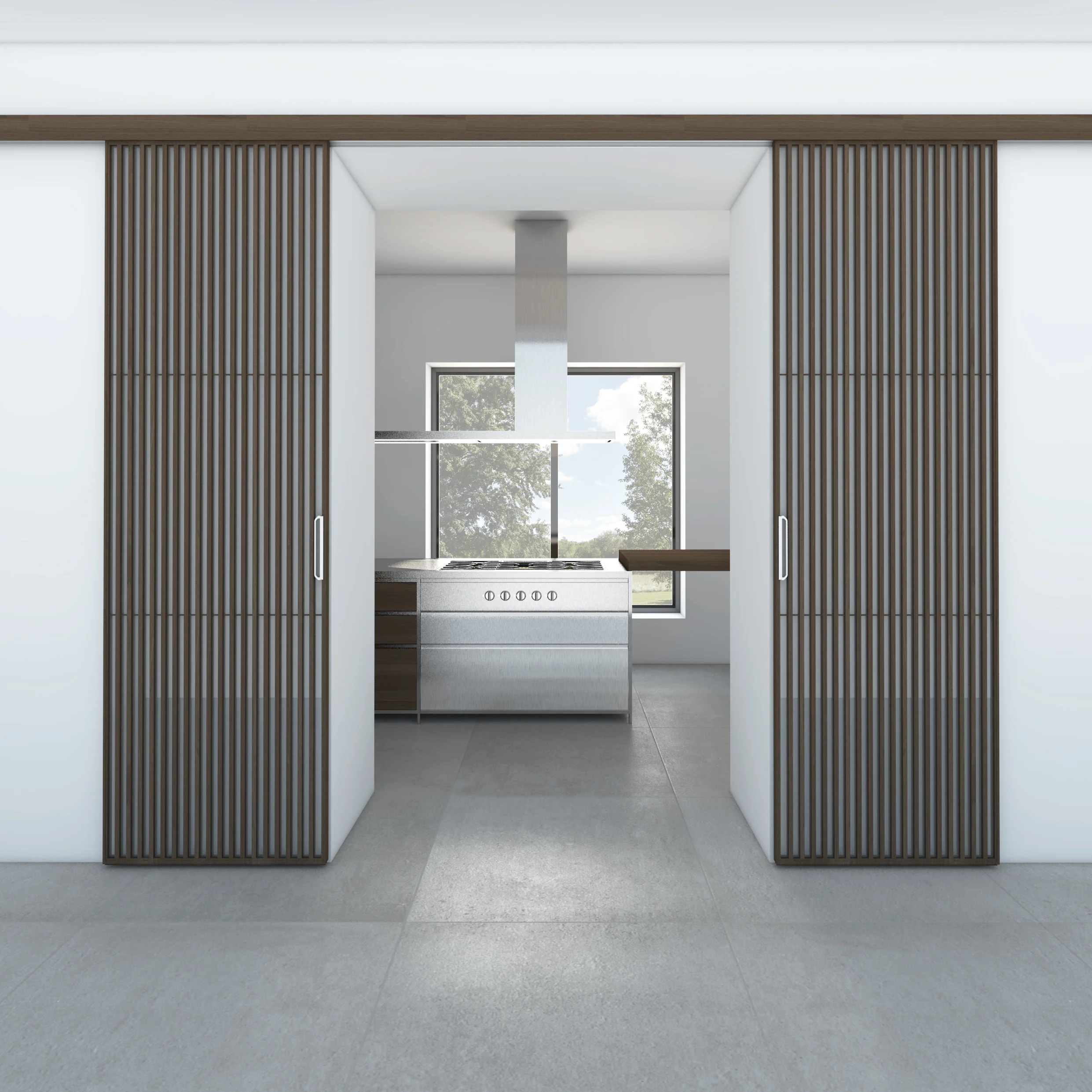 2. Spazio living/cucina. Isola Valcucine Meccanica inox, con piano cottura Gaggenau a incasso, Porte scorrevoli Sail Rimadesio. 