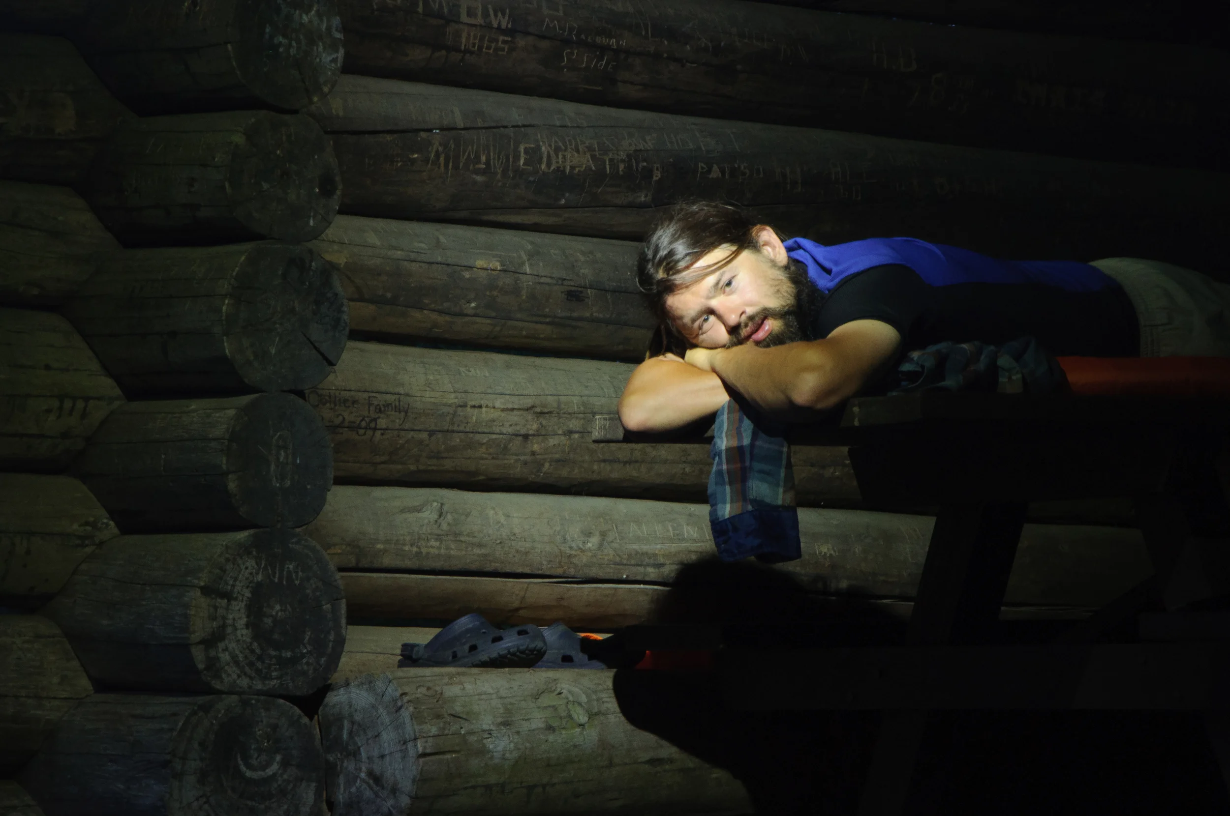 I moved in closer to capture the quiet, beauty of the evening. Also to capture Jared more intimately in the shelter along with the details of the carvings in the wood behind him. A beautiful night to soak it all in, create, listen to an audio book, and watch the sunset. 