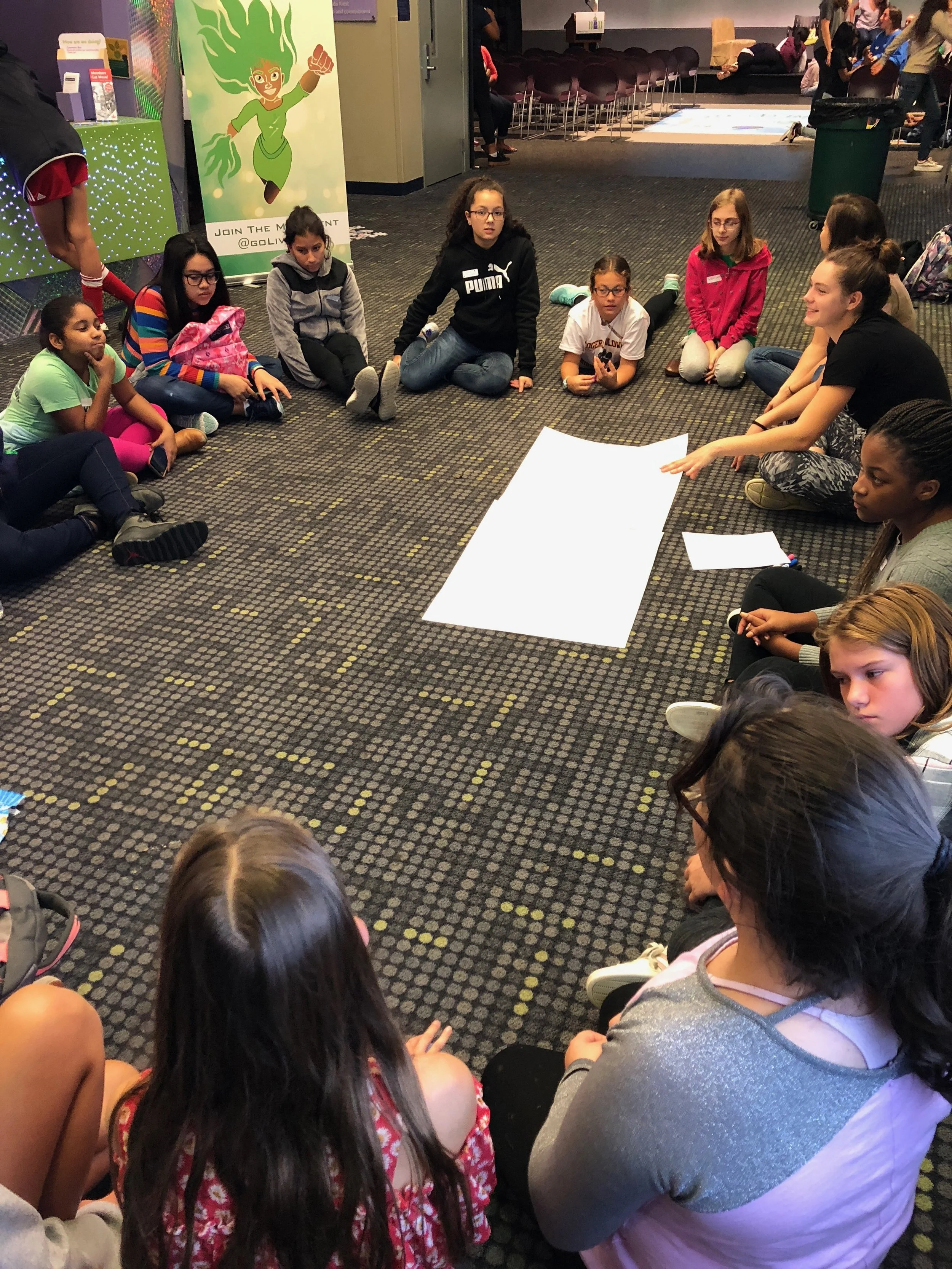 High School Mentors facilitate a discussion with middle school girls around the International Day of the Girl.