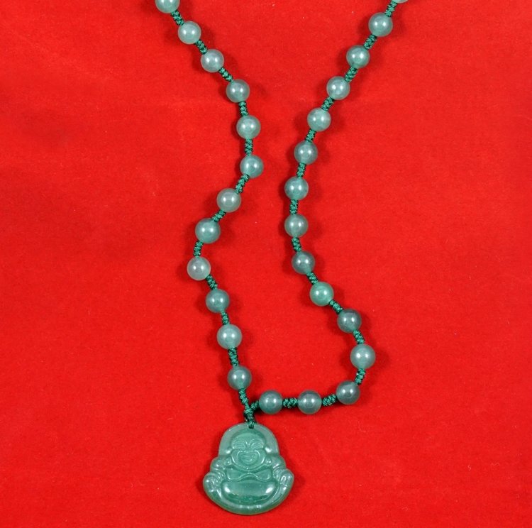 jade_buddha_necklace_on_red.jpg