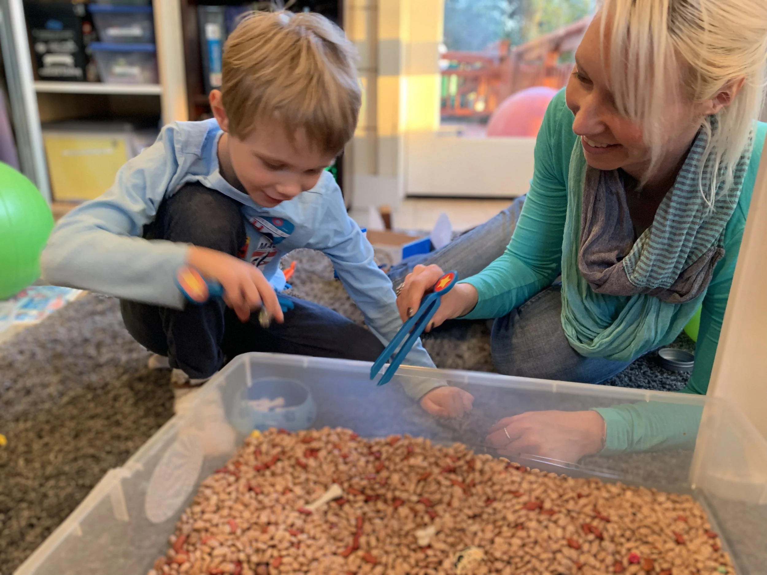Playing archaeologist with tweezers to find the hidden bones in the beans.