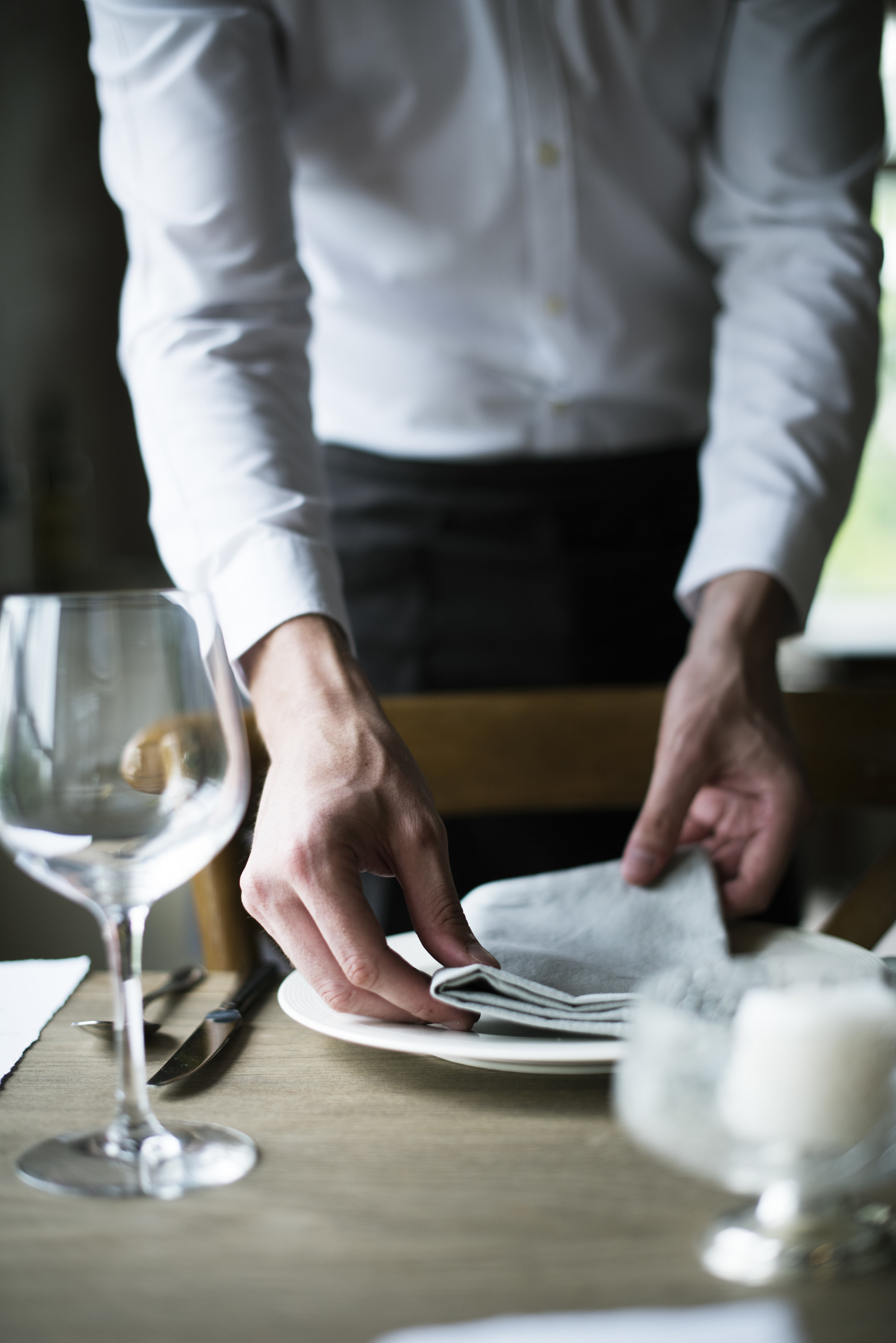 restaurant-staff-setting-table-in-restaurant-for-PJAKTJR.jpg