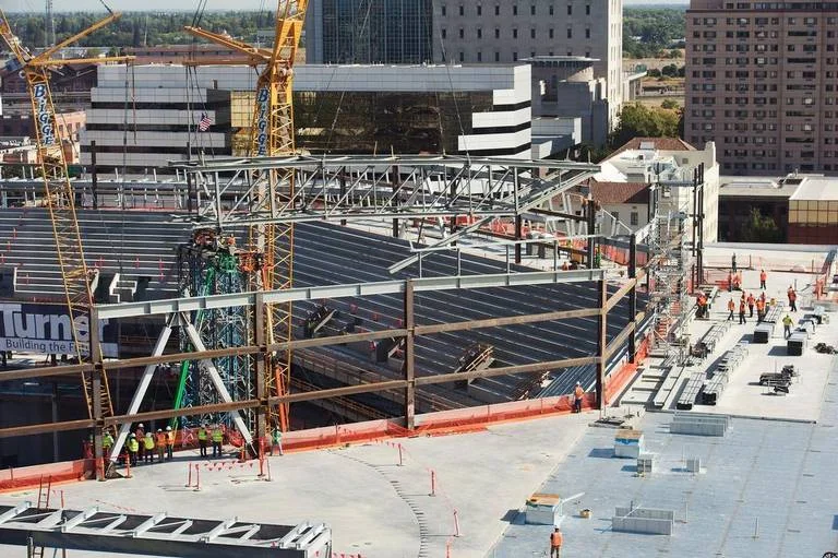 Workers watch as the first major section of the roof trusses is installed at the Golden 1 Center on Monday in downtown Sacramento. The 120-foot-long truss weighs 90,000 pounds and is the first of six major trusses to be lowered into place by a large crane. Approximately 180 workers fabricated the trusses in Schuff Steel's Stockton facility. Construction of the Golden 1 Center is on time and the arena is scheduled to open October 2016.