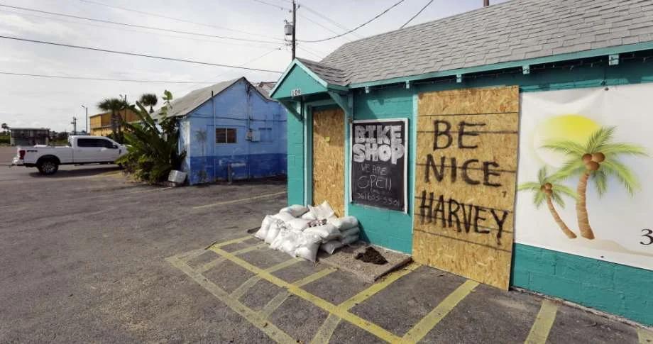 A sign reading "Be Nice Harvey" was left behind on a boarded up business, Thursday, Aug. 24, 2017, in Port Aransas, Texas. Port Aransas is under a mandatory evacuation for Hurricane Harvey. Harvey intensified into a hurricane Thursday and steered for the Texas coast.
