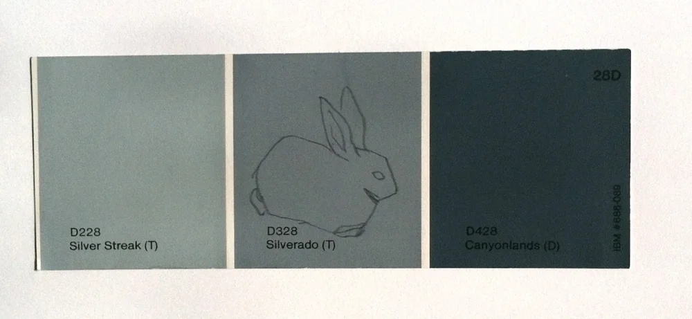 Kate Shepherd, lone rabbit on grey, 1996, graphite on paint chip 2 x 6 inches.jpg